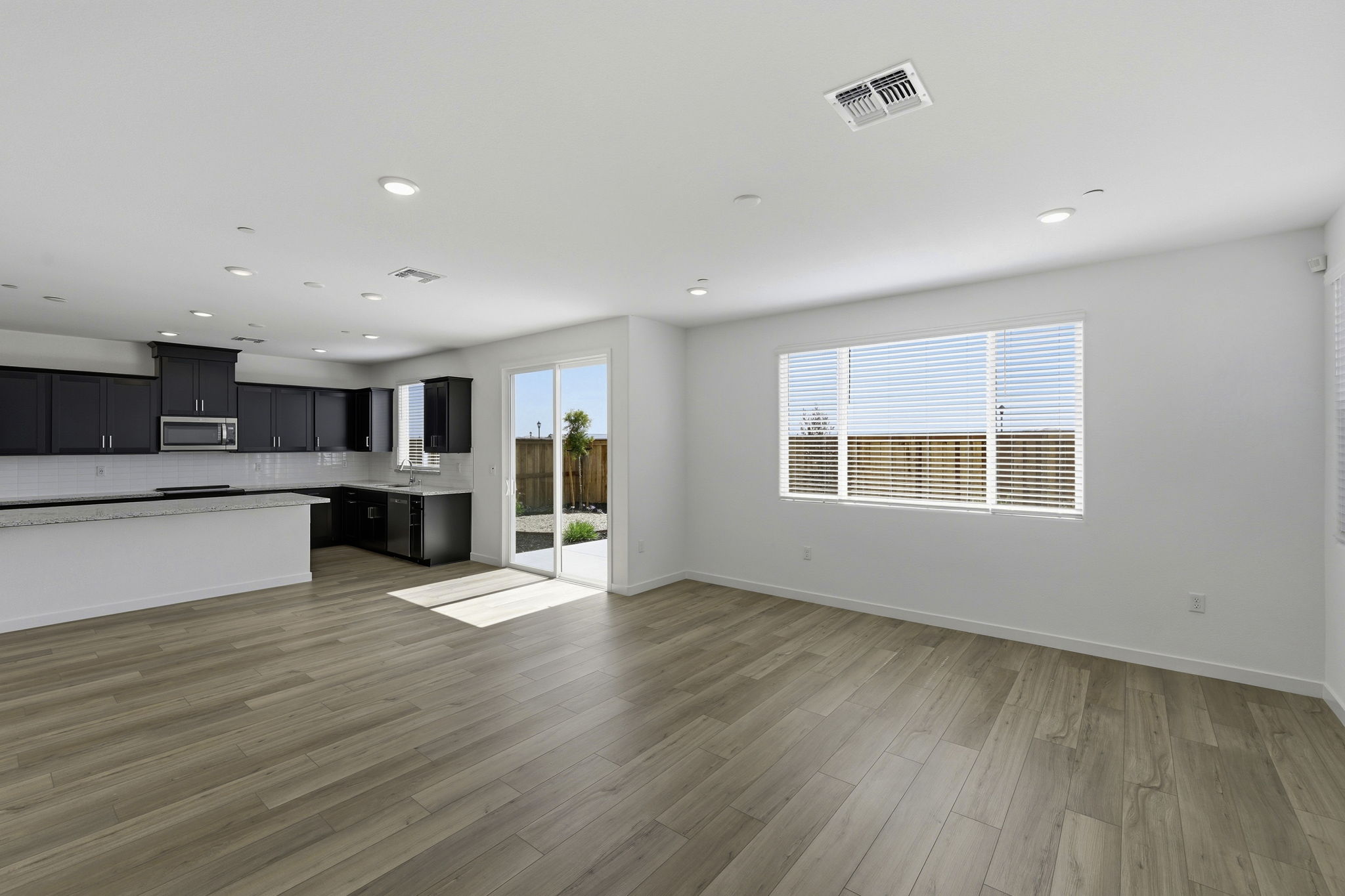 A large empty room with a wood floor and a wood floor.