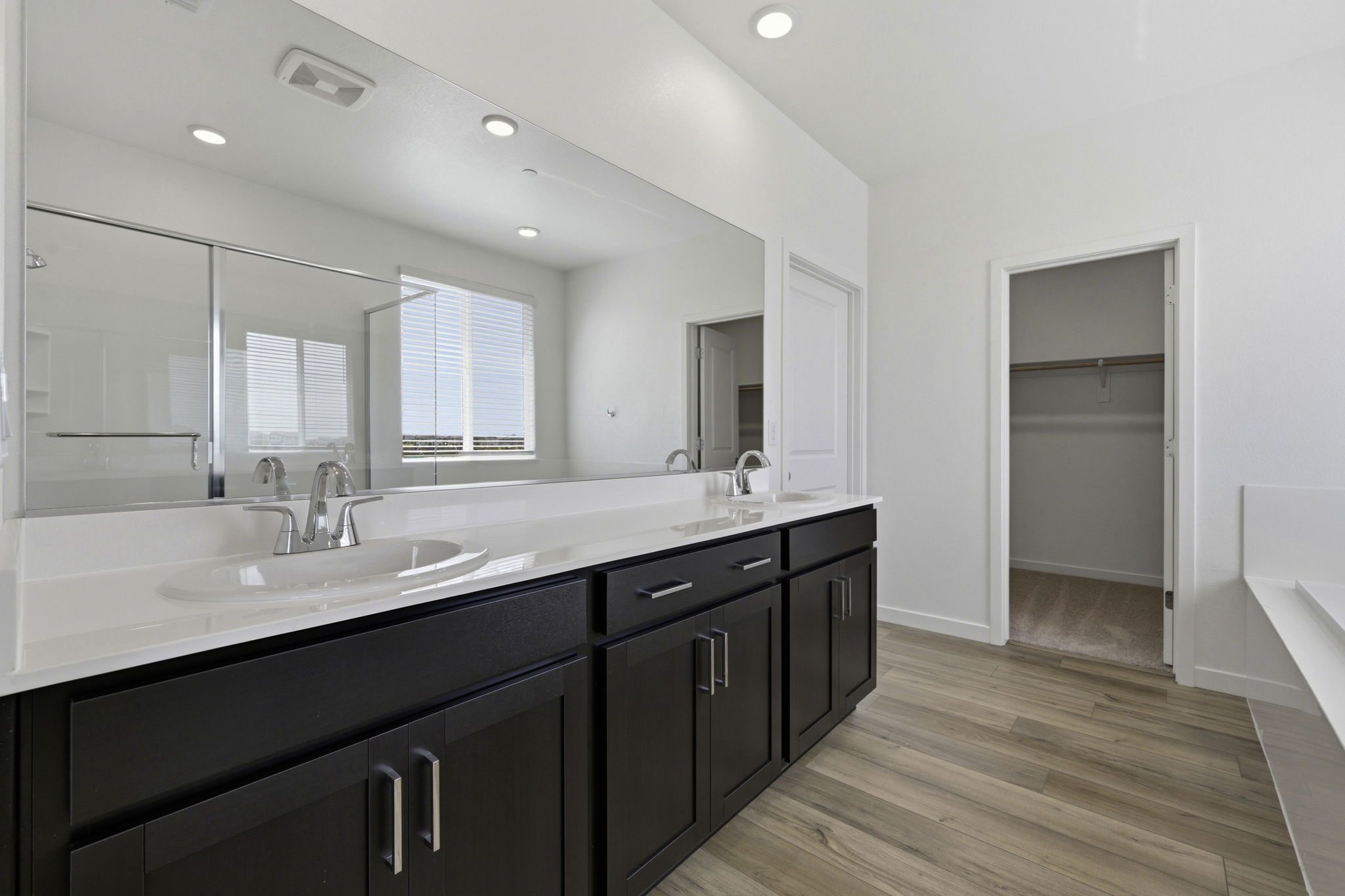 A bathroom with a large mirror.