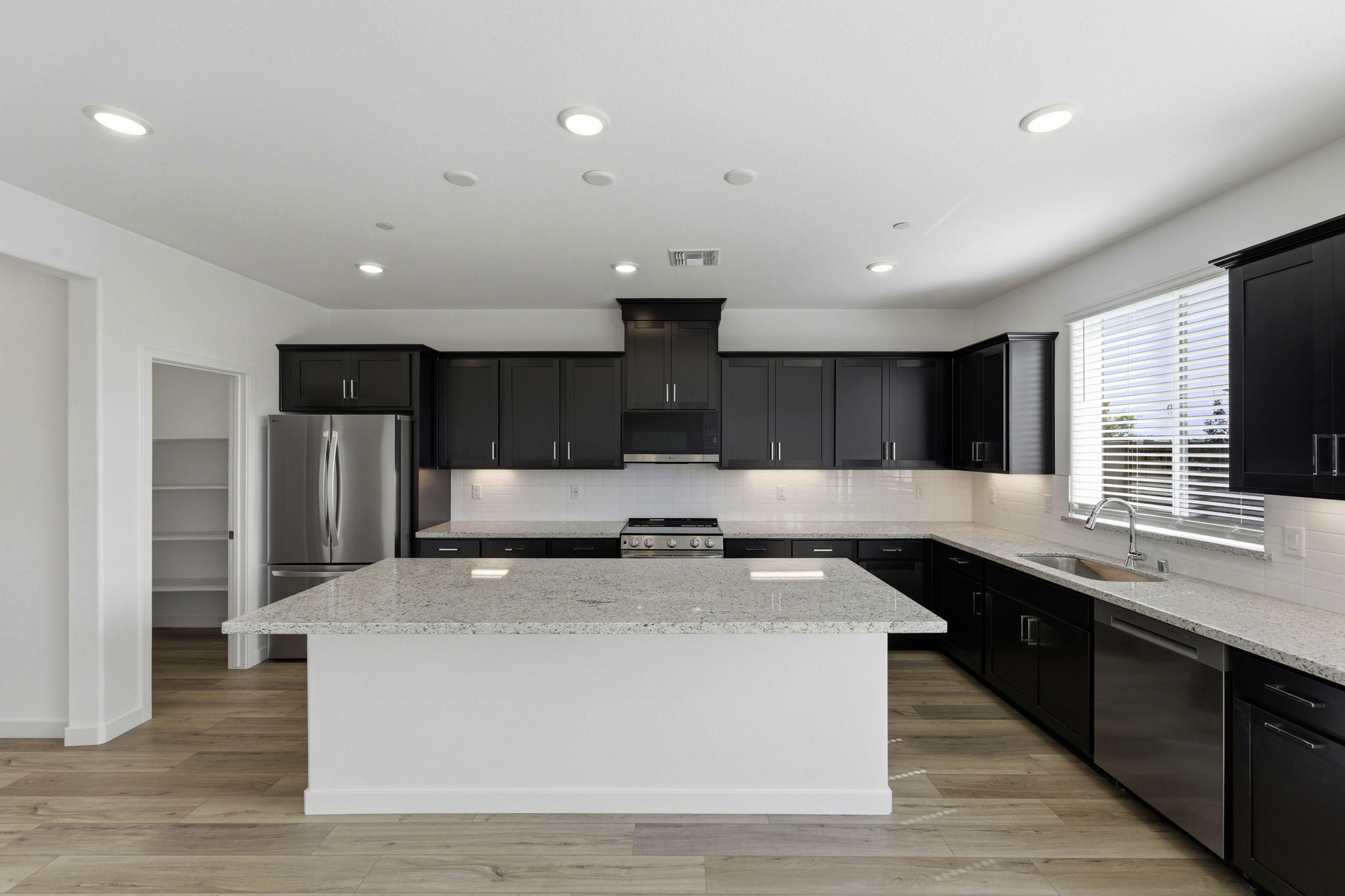 A kitchen with black cabinets.