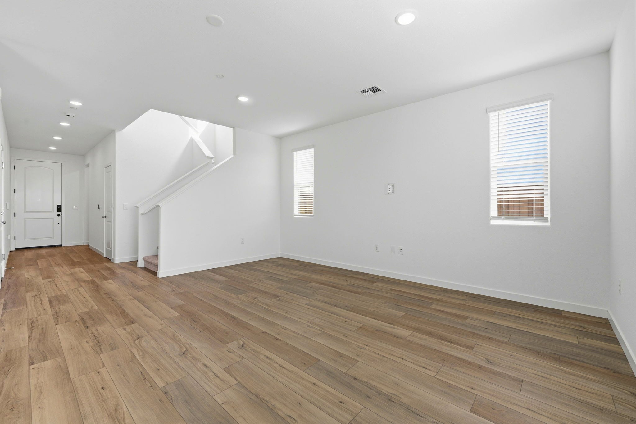 A room with a wood floor and white walls.