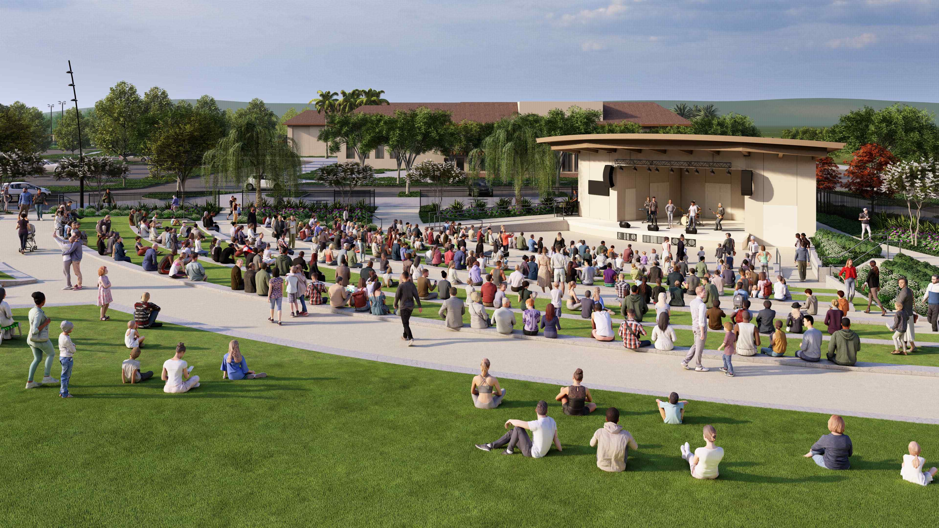 A group of people sitting on the grass in front of a building.