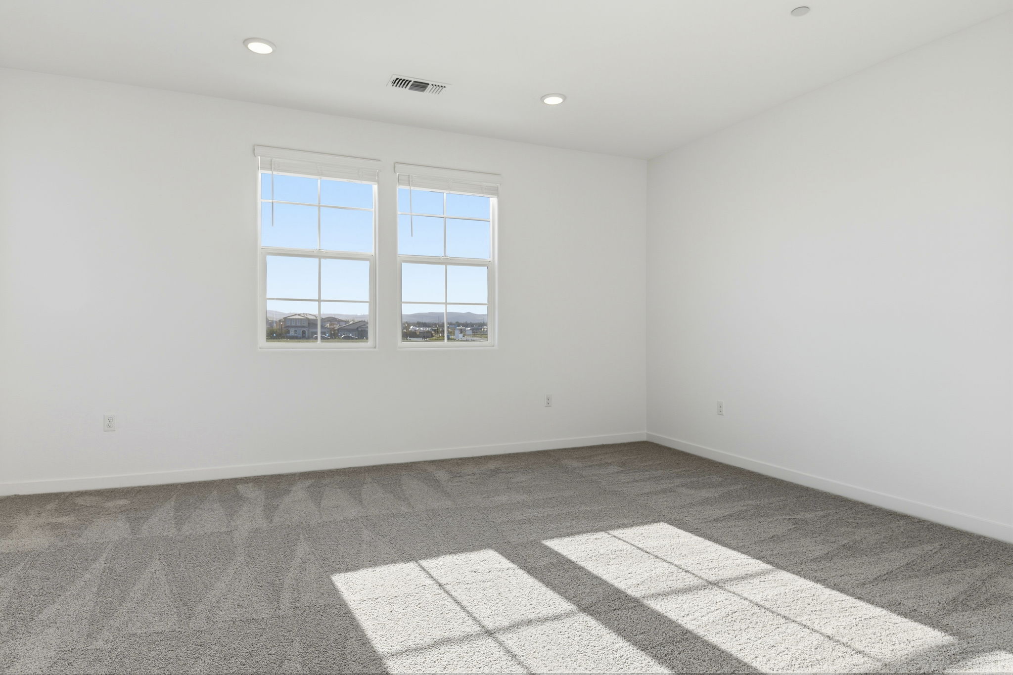 A room with a tile floor and windows.