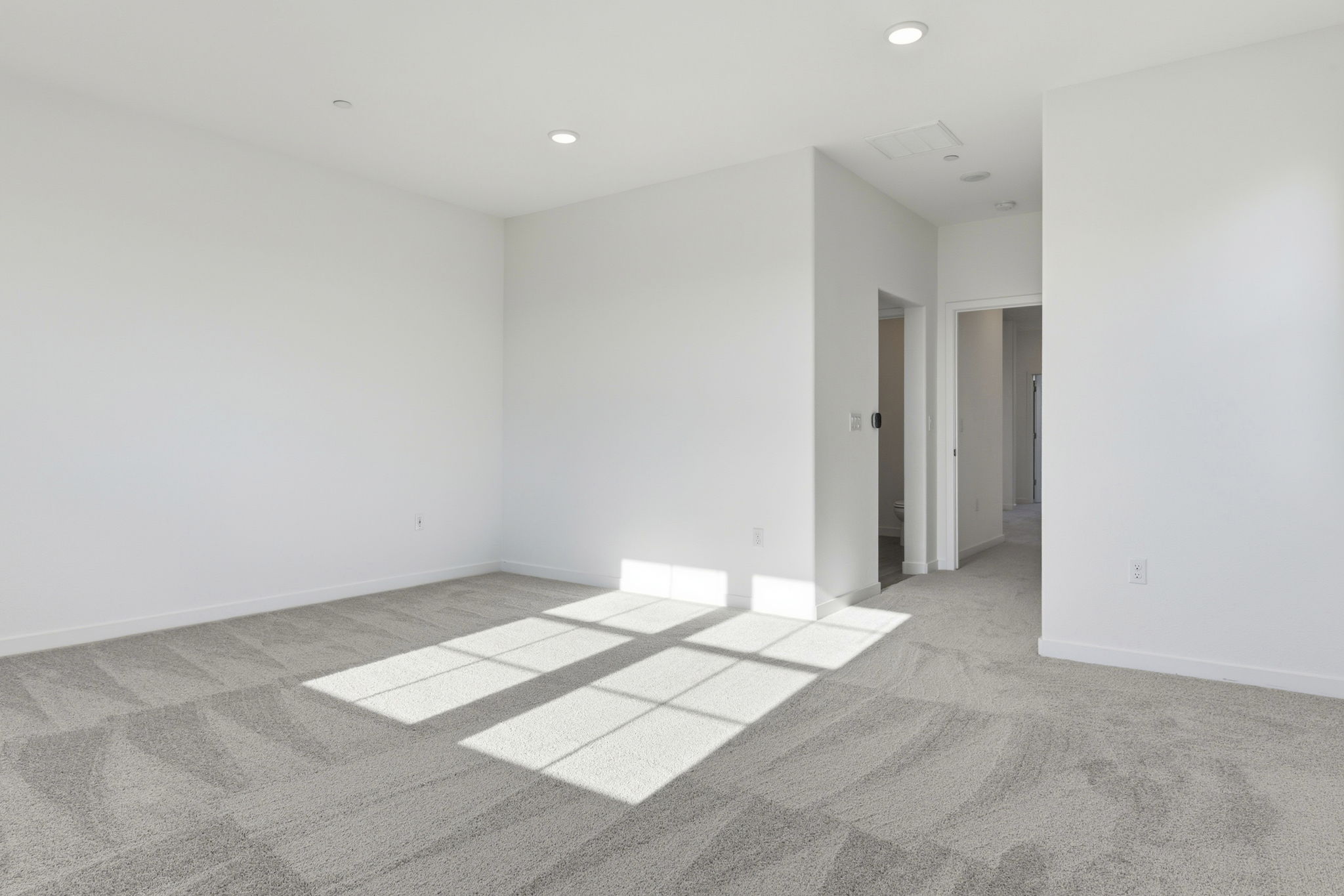 A hallway with white walls.