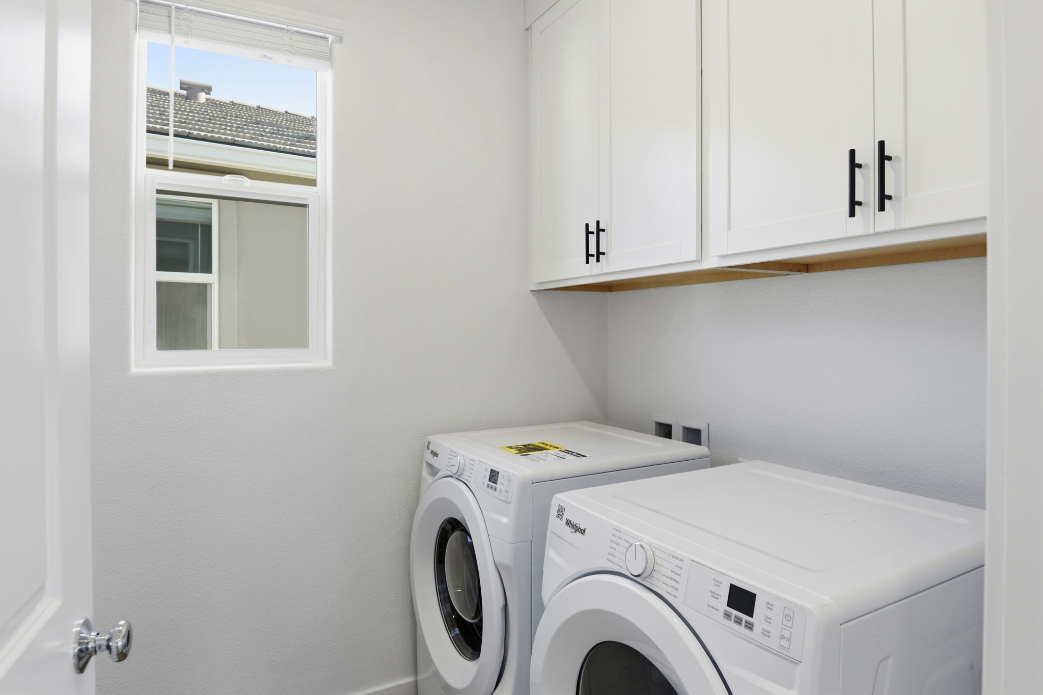 A washing machine in a room.