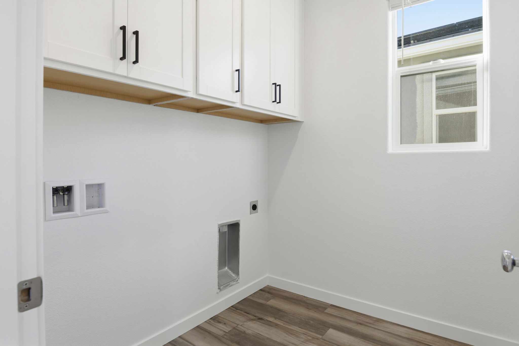 A room with white cabinets.