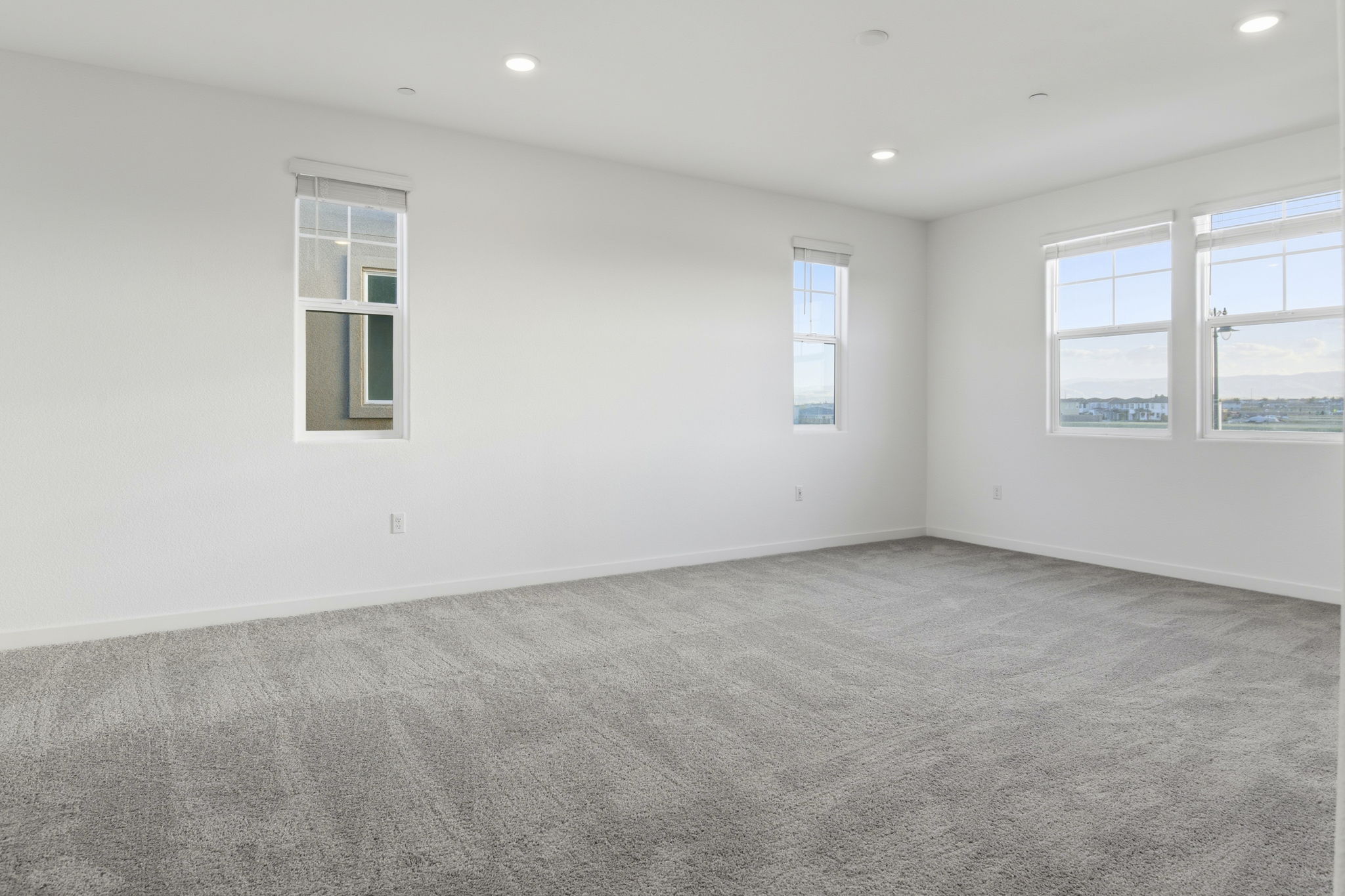 A room with windows and carpet.