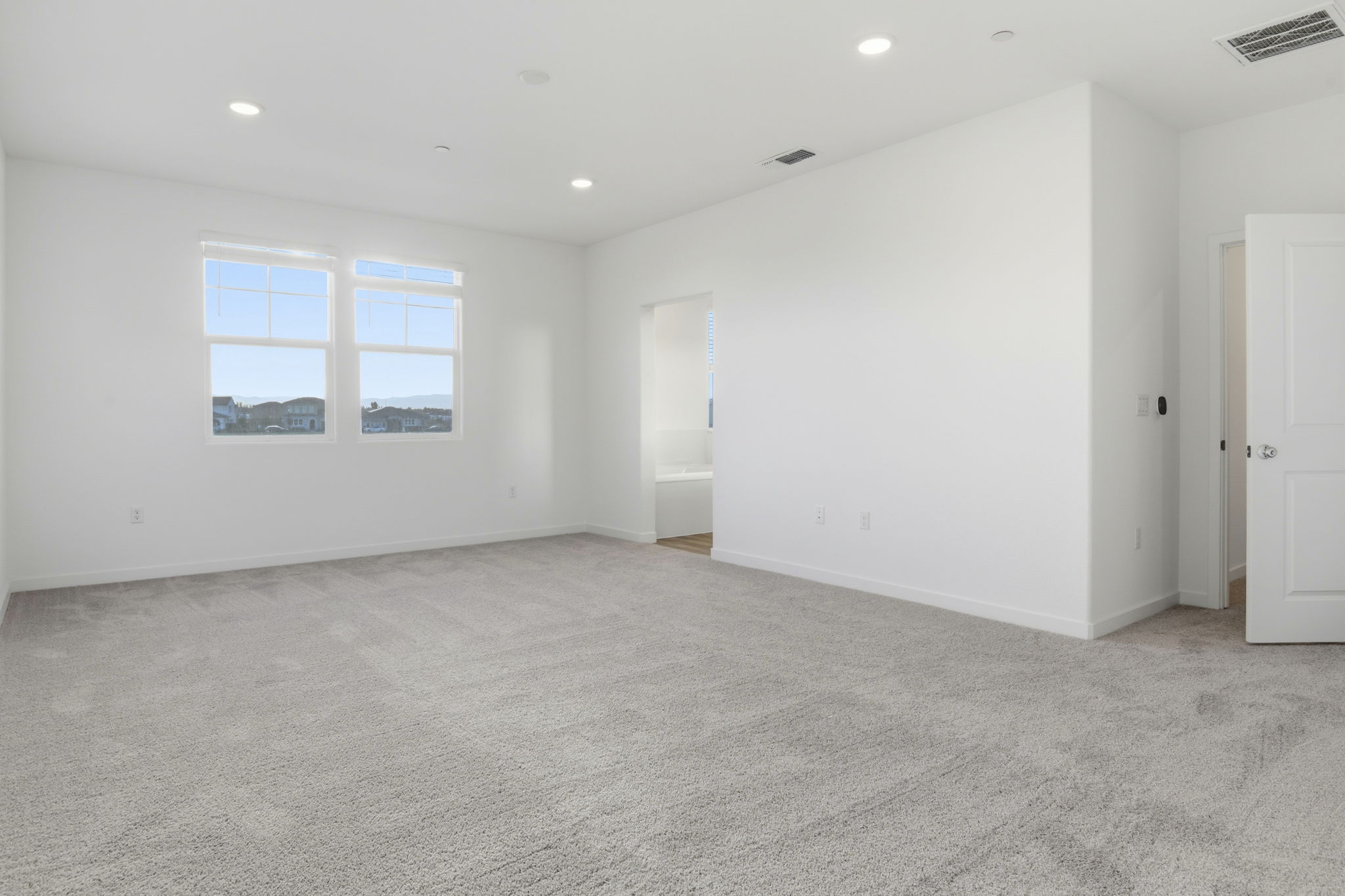 A room with white walls and a window.
