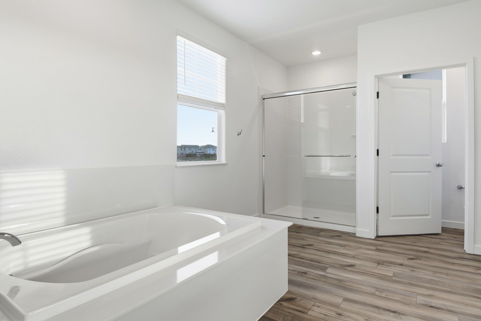 A bathroom with a tub and a shower.