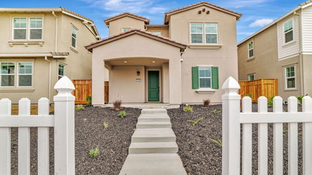 A white fence in front of a house.