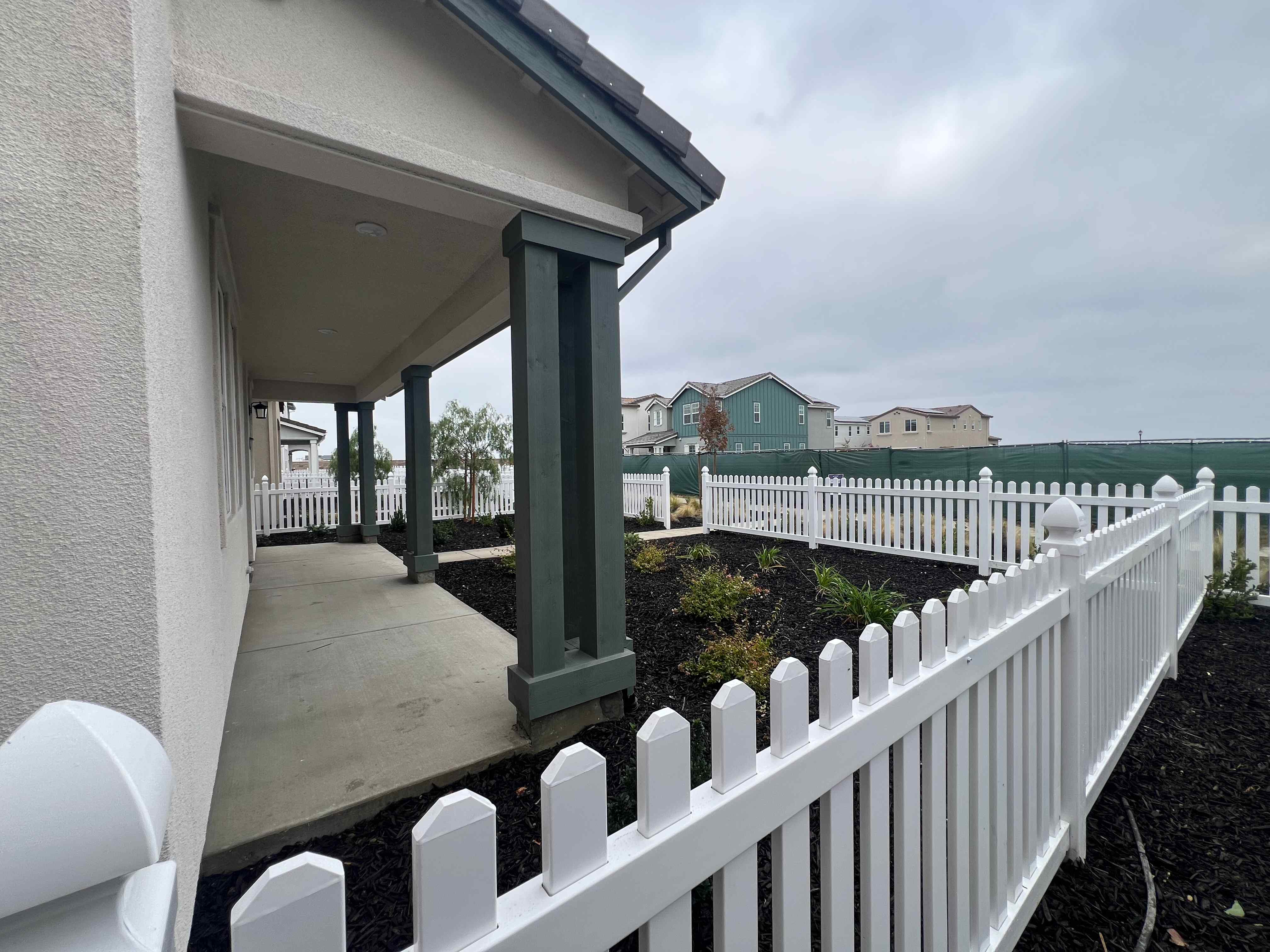 A white fence with a white railing.