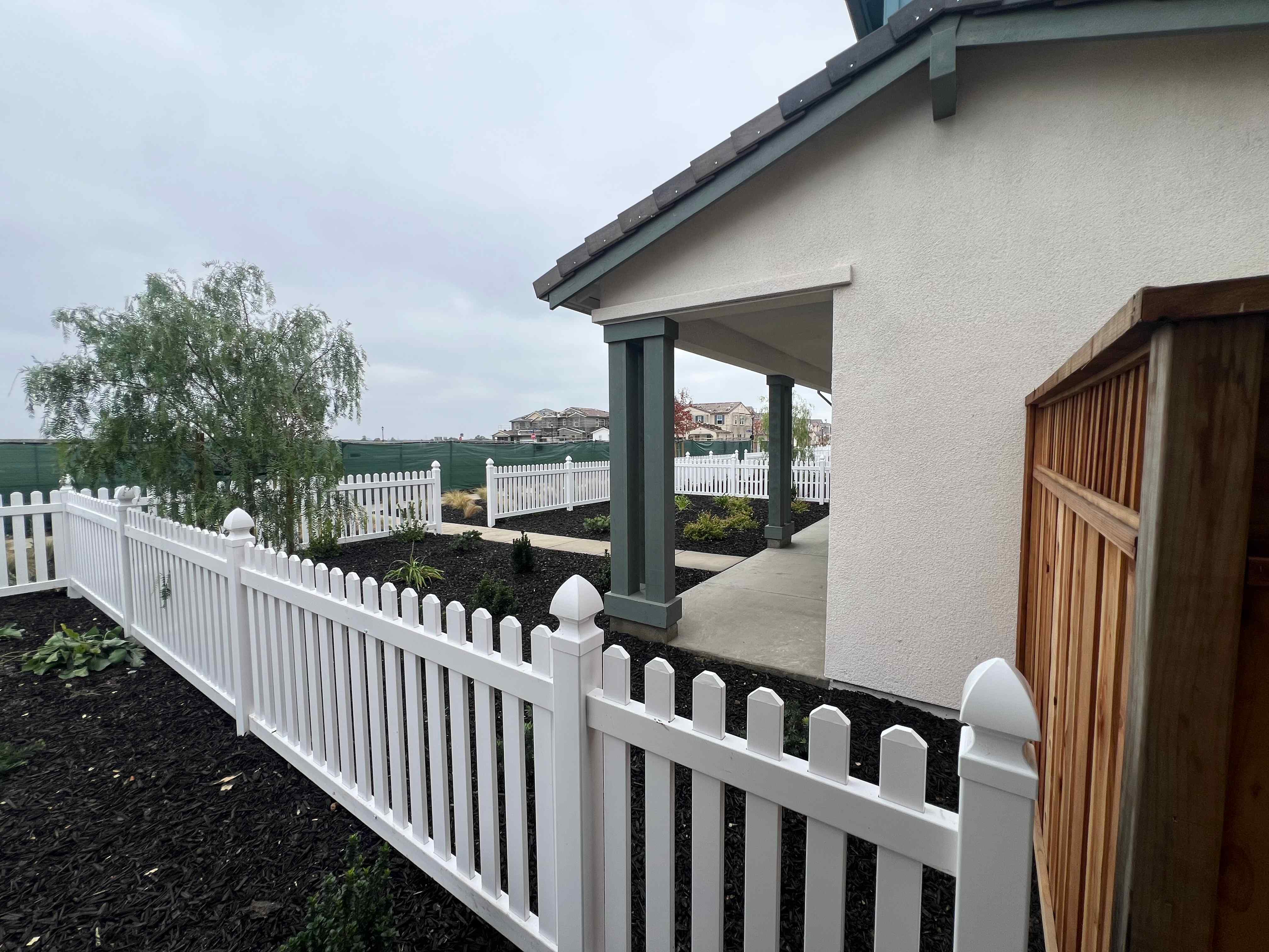 A white fence with a white railing.