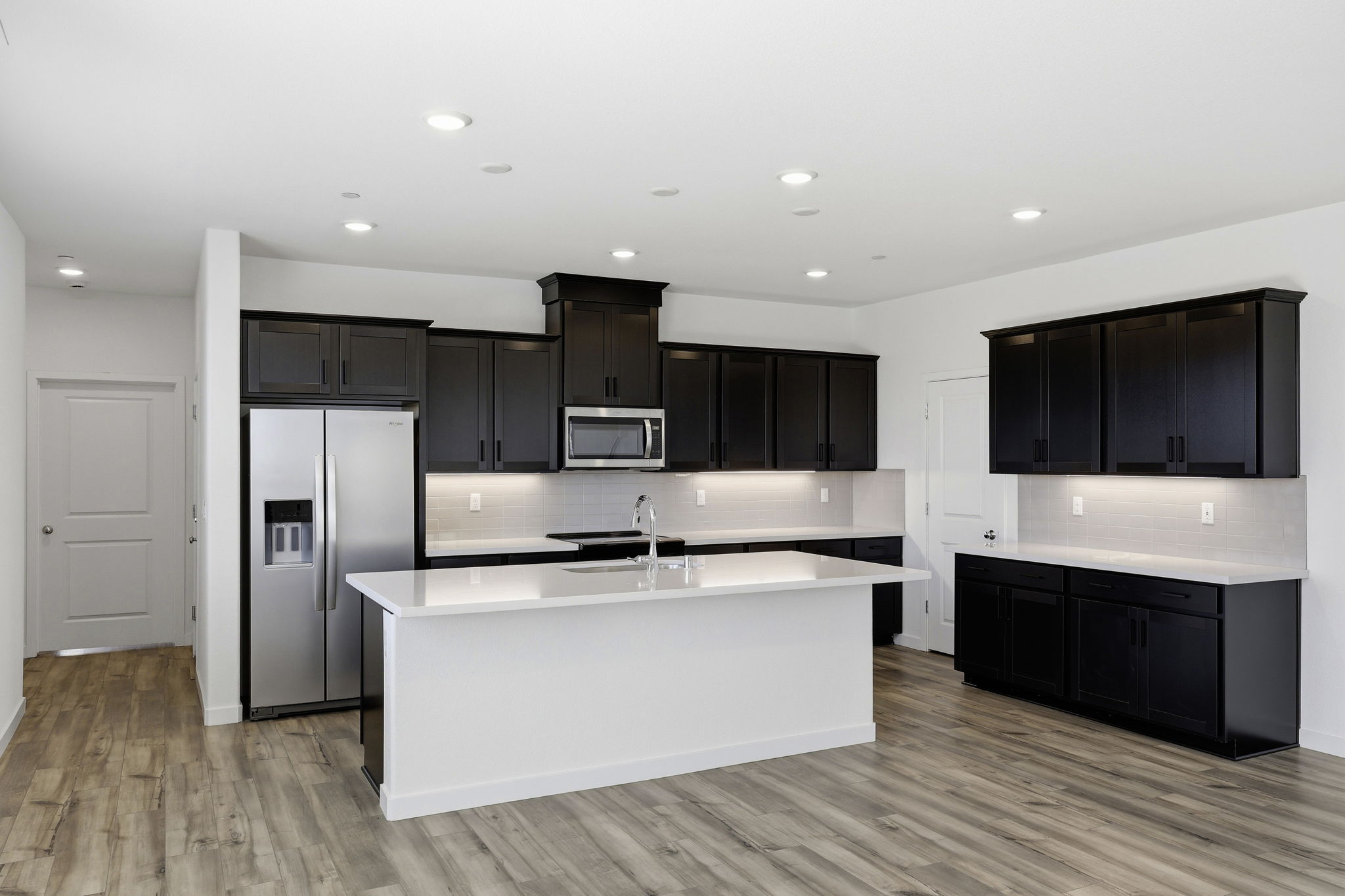A kitchen with black cabinets.