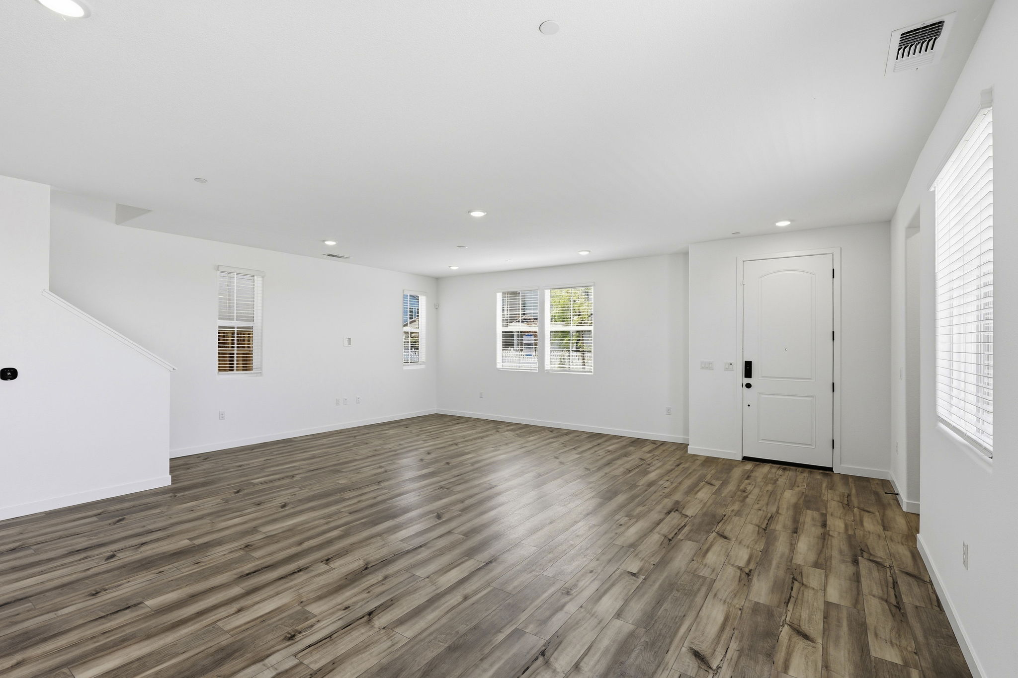 A room with white walls and wood floors.