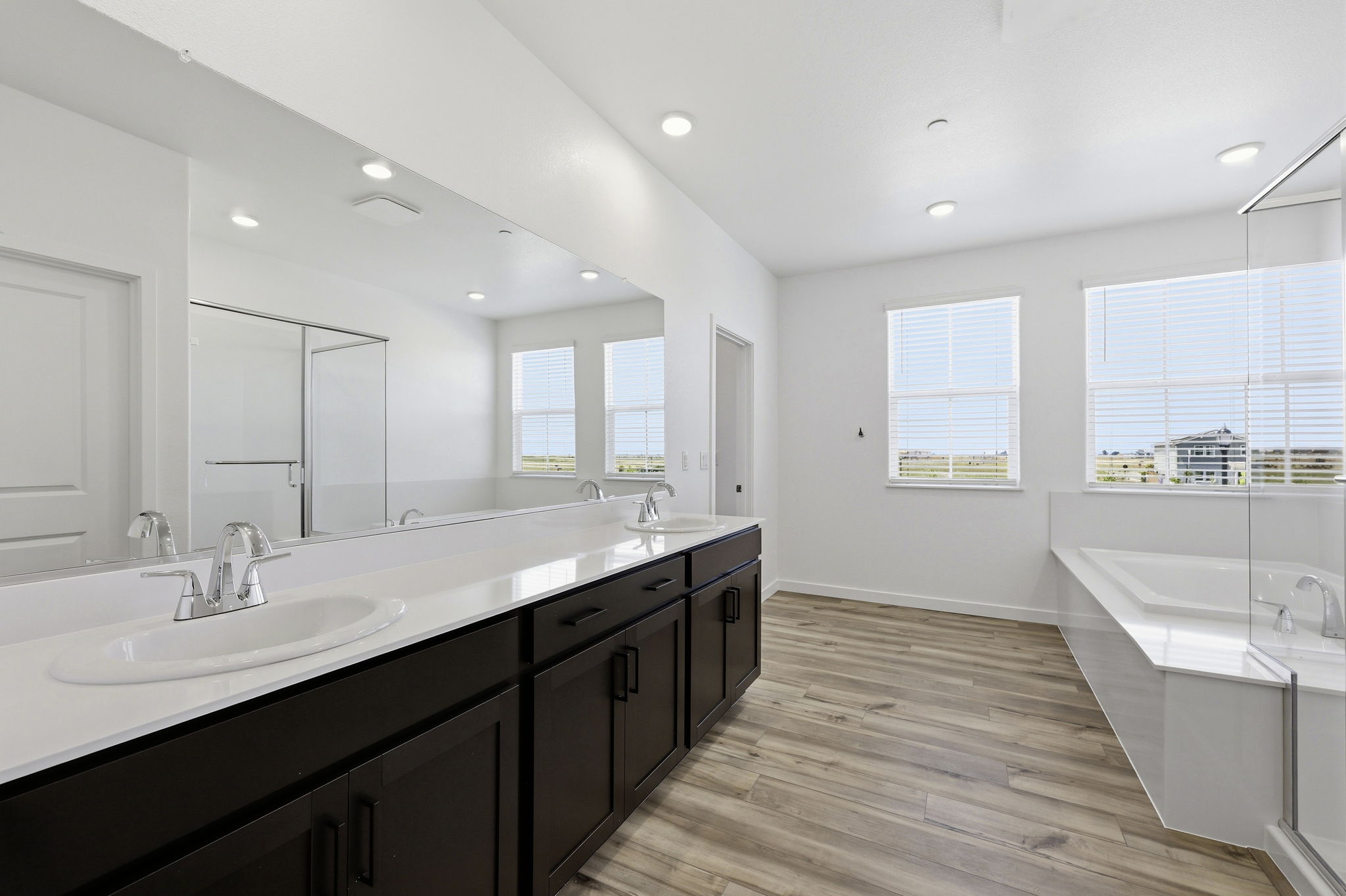 A bathroom with a large tub and sink.