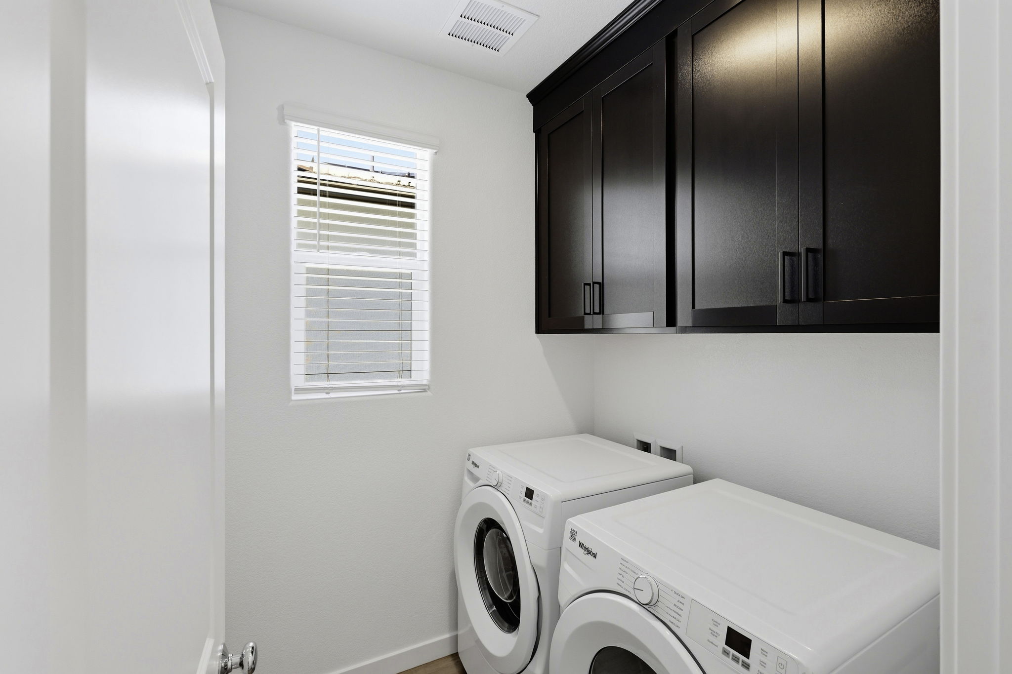A washing machine and dryer in a room.