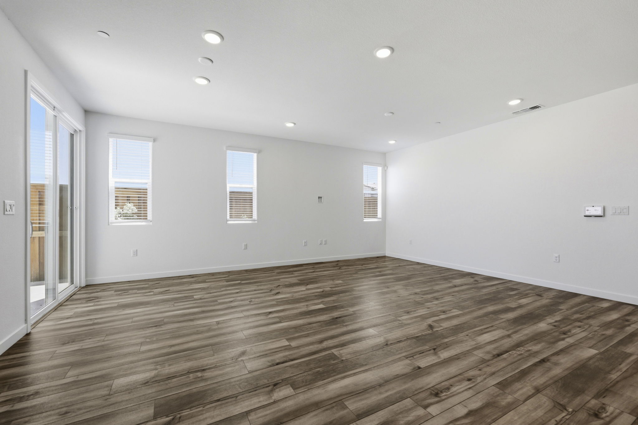 A room with a wood floor and white walls.