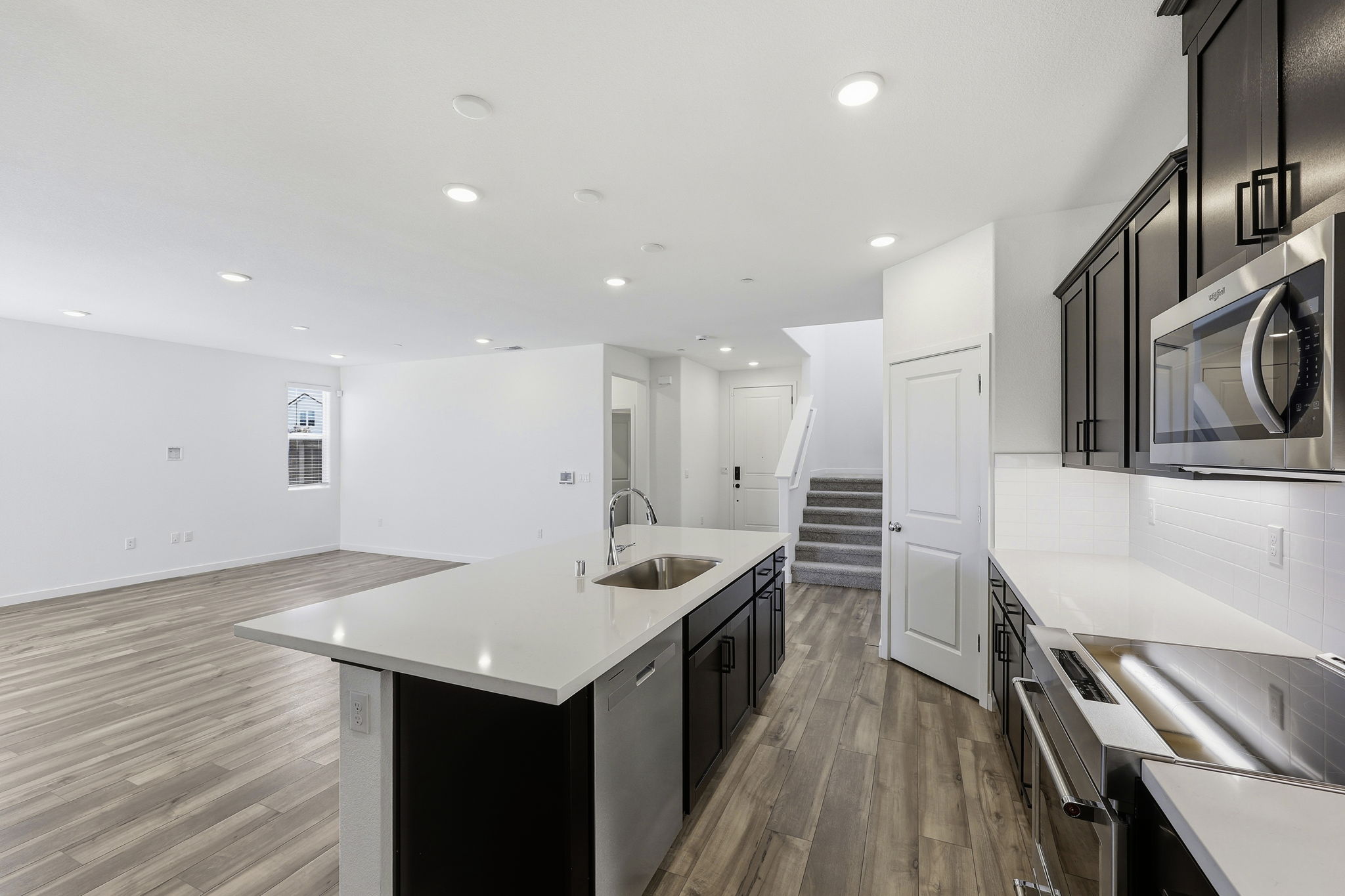 A kitchen with black cabinets.