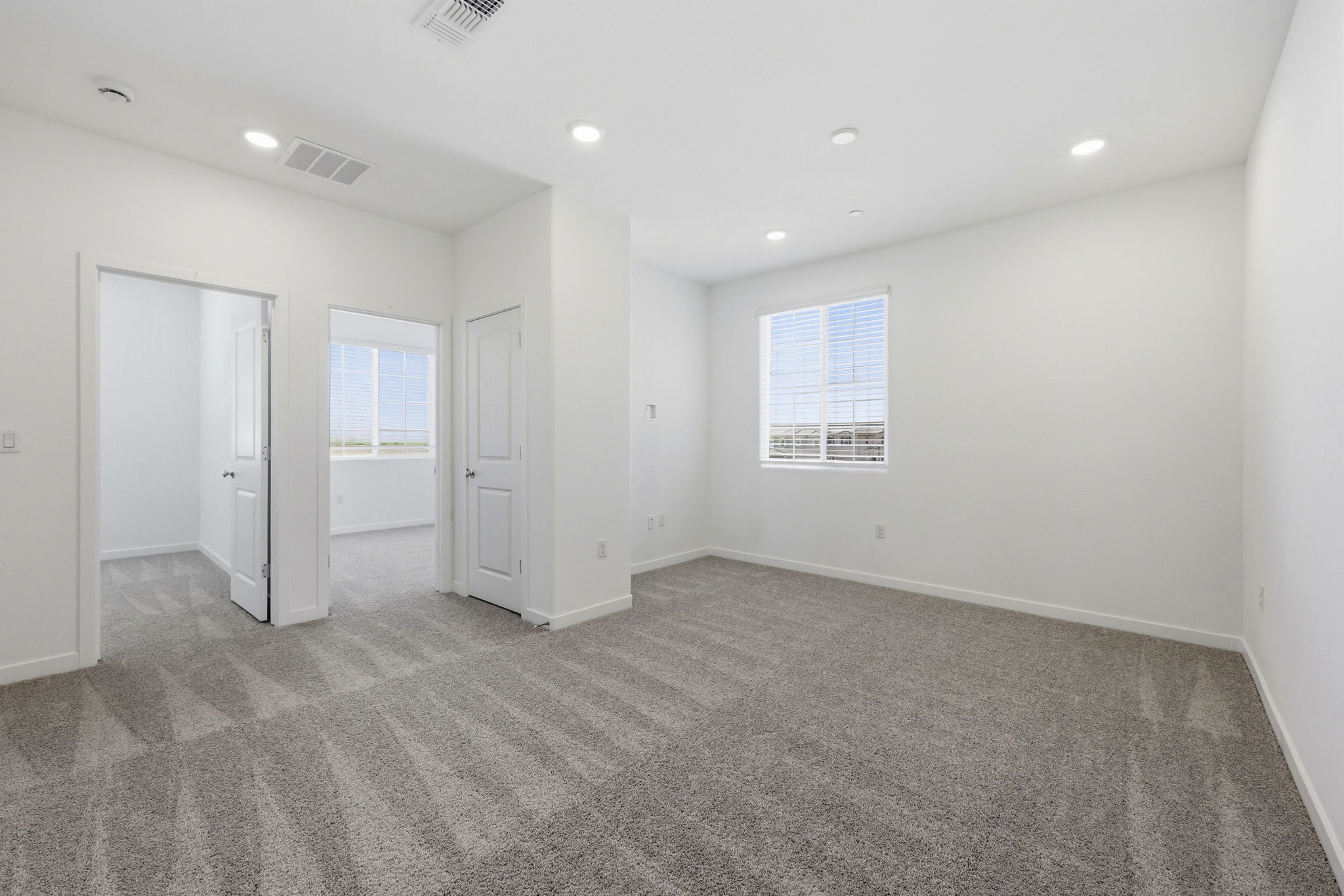 A room with white walls and a carpeted floor.