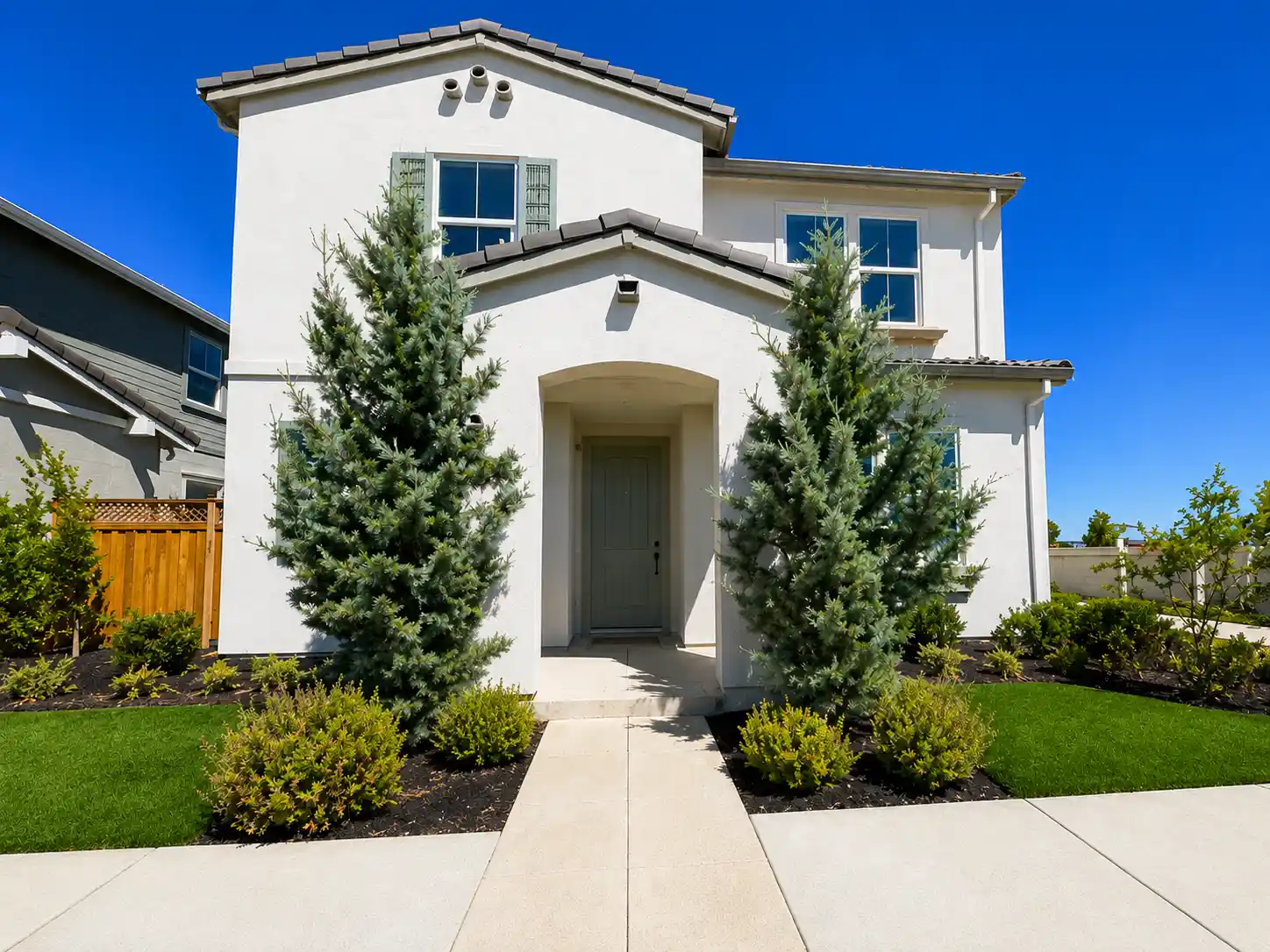 A house with a driveway and trees.
