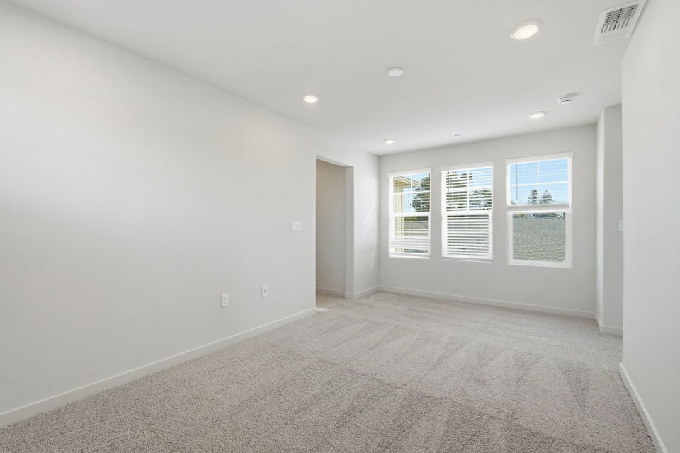 A room with a carpet and a door.