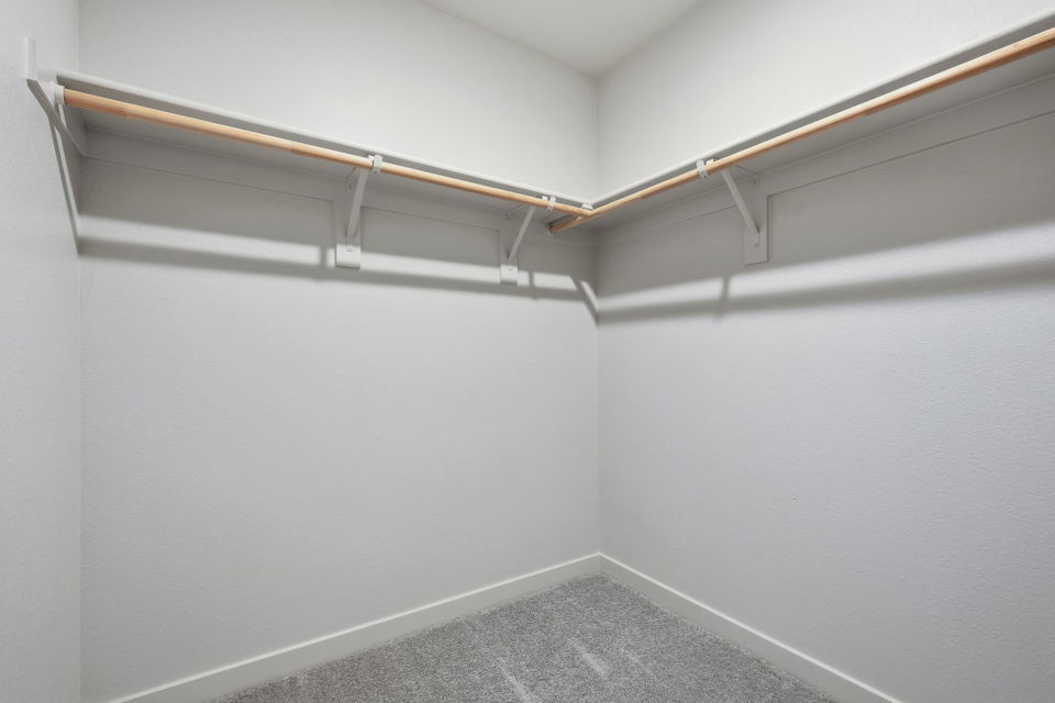 A white wall with a metal railing.