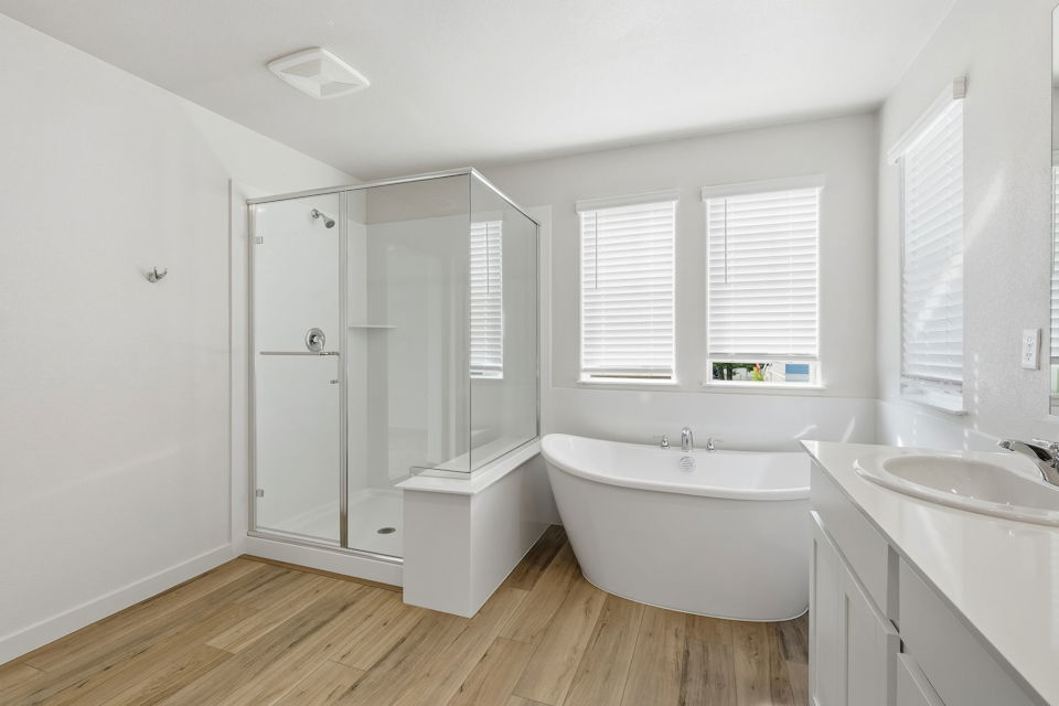 A bathroom with a tub and sink.