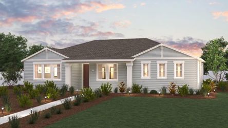 A house with a lawn and a fence in front of it.