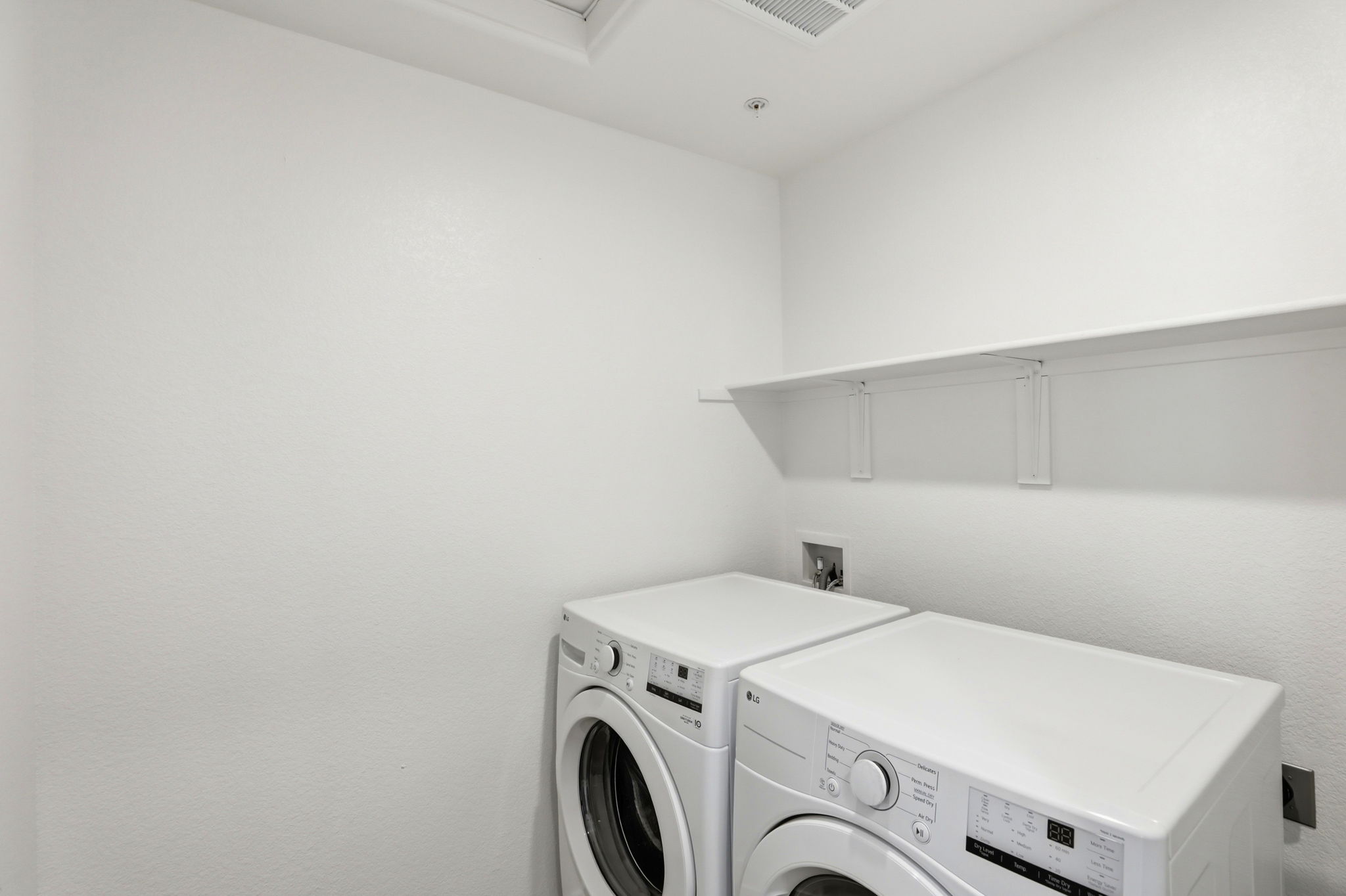 A white room with a washing machine and dryer.
