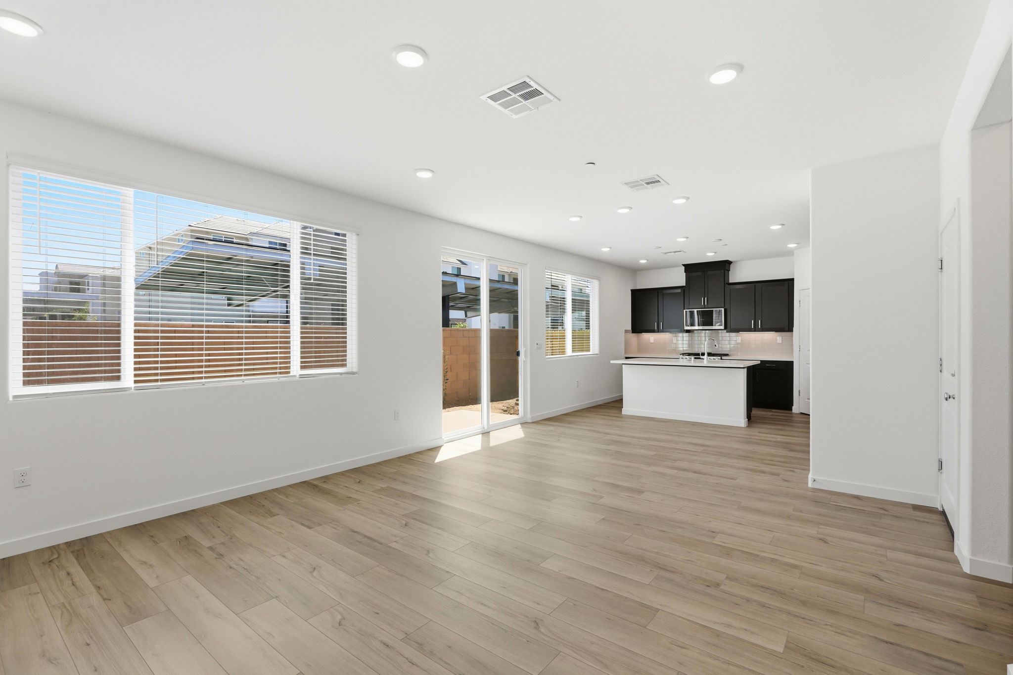 A large kitchen with a wood floor.