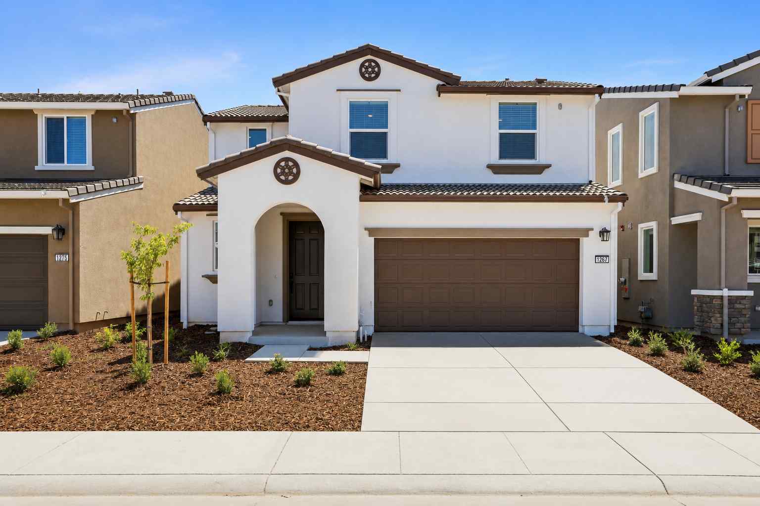 A white house with a garage.