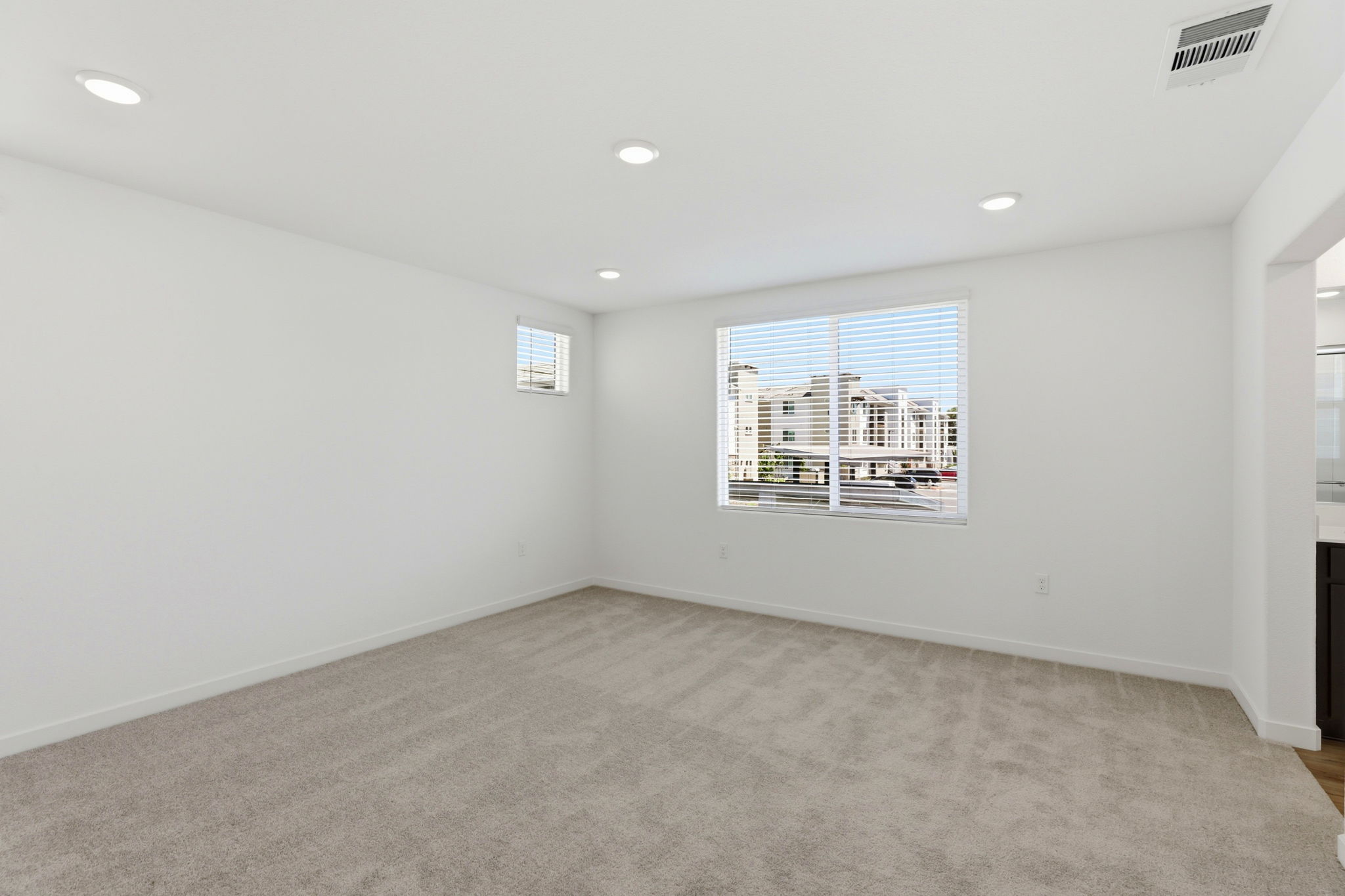 A room with a window and a carpet.