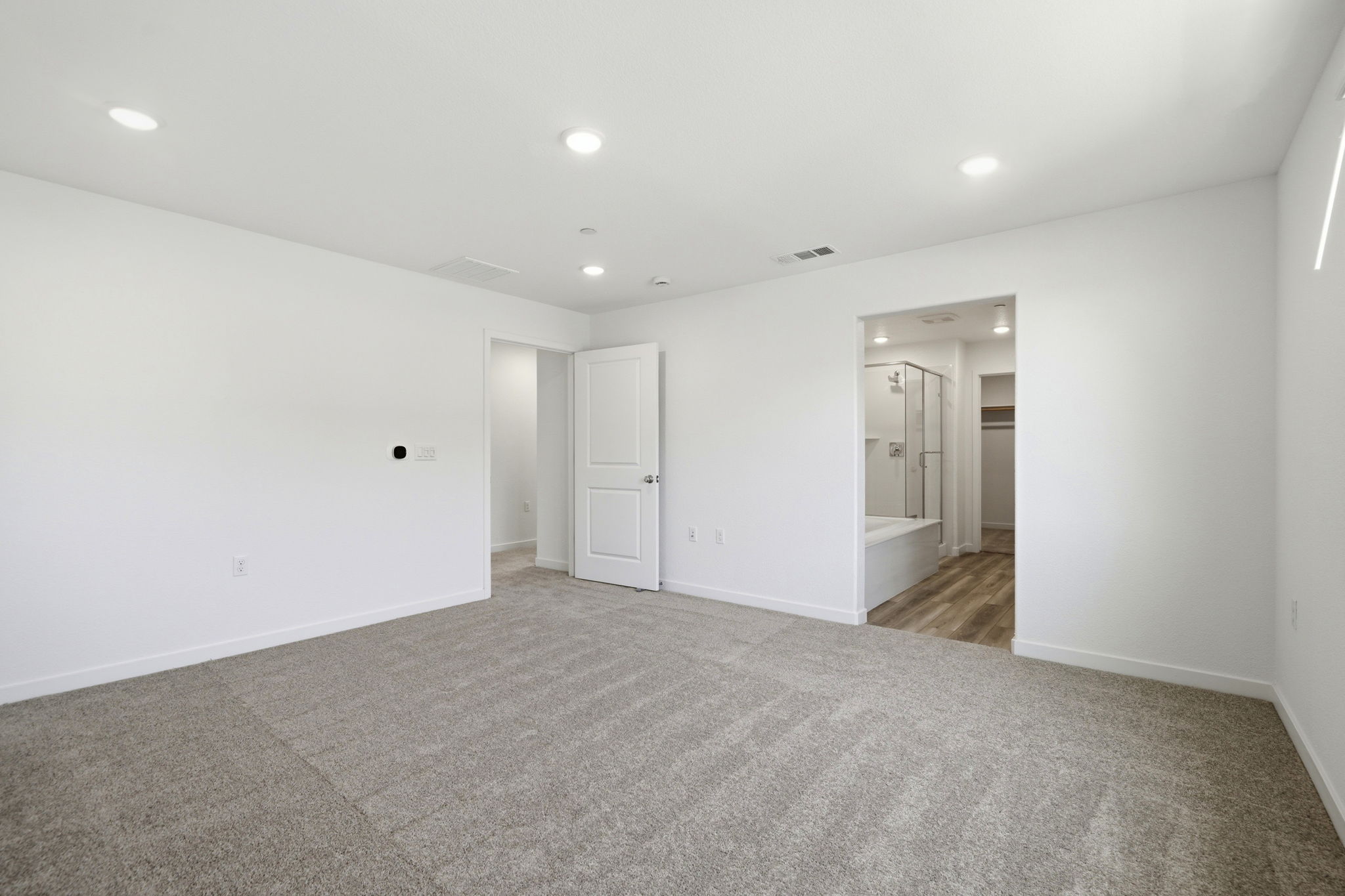A long hallway with white walls.
