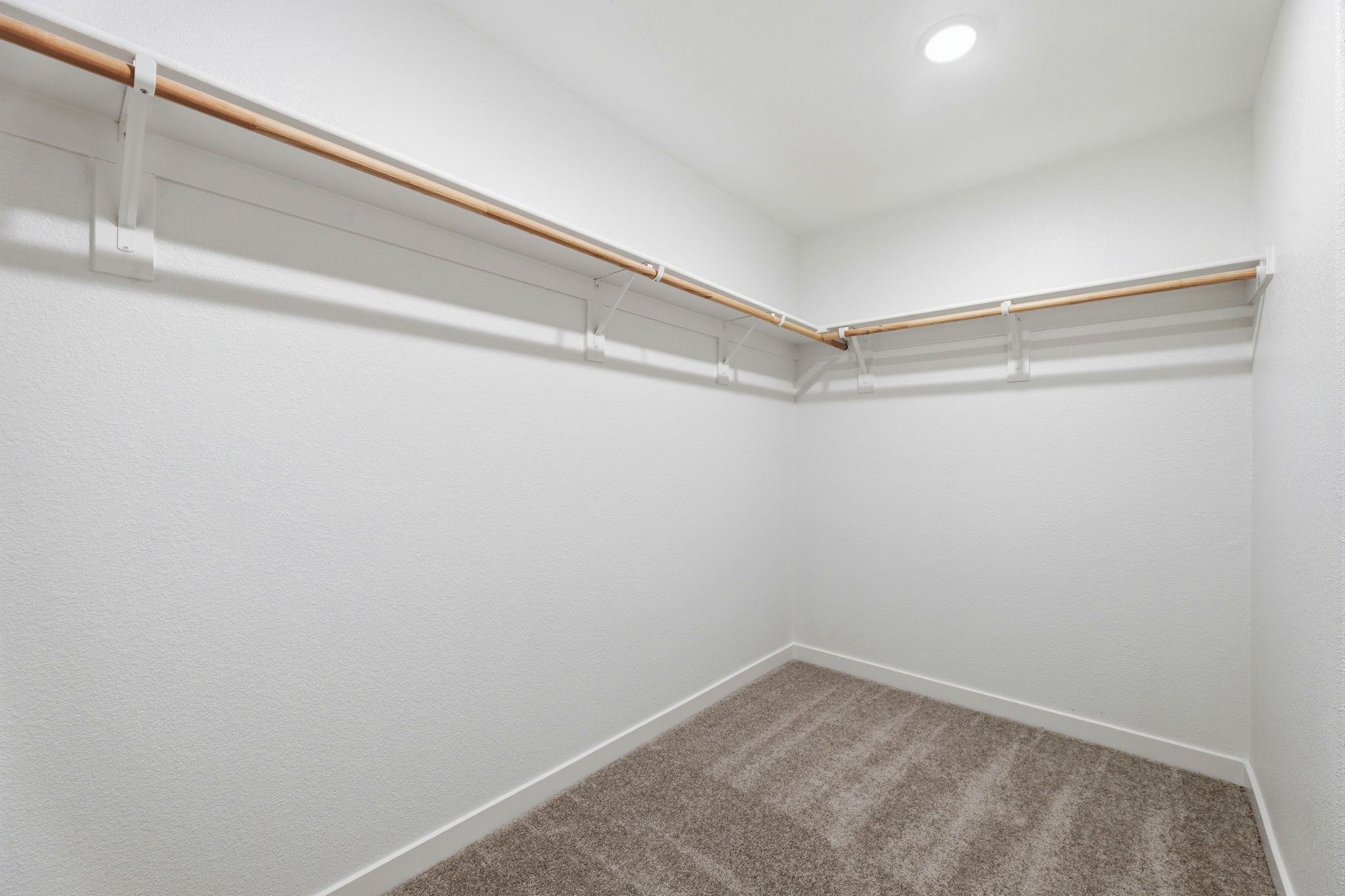 A white room with a carpet.
