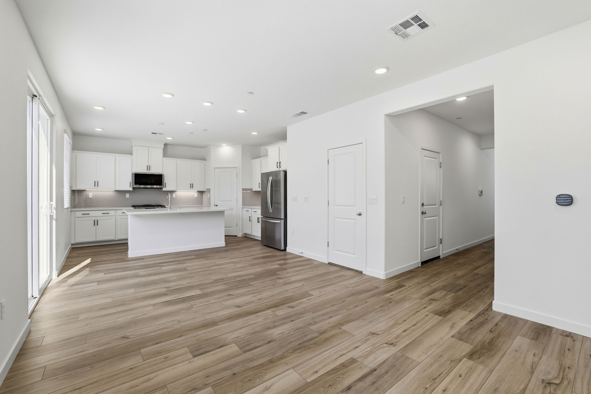 A large kitchen with white cabinets.