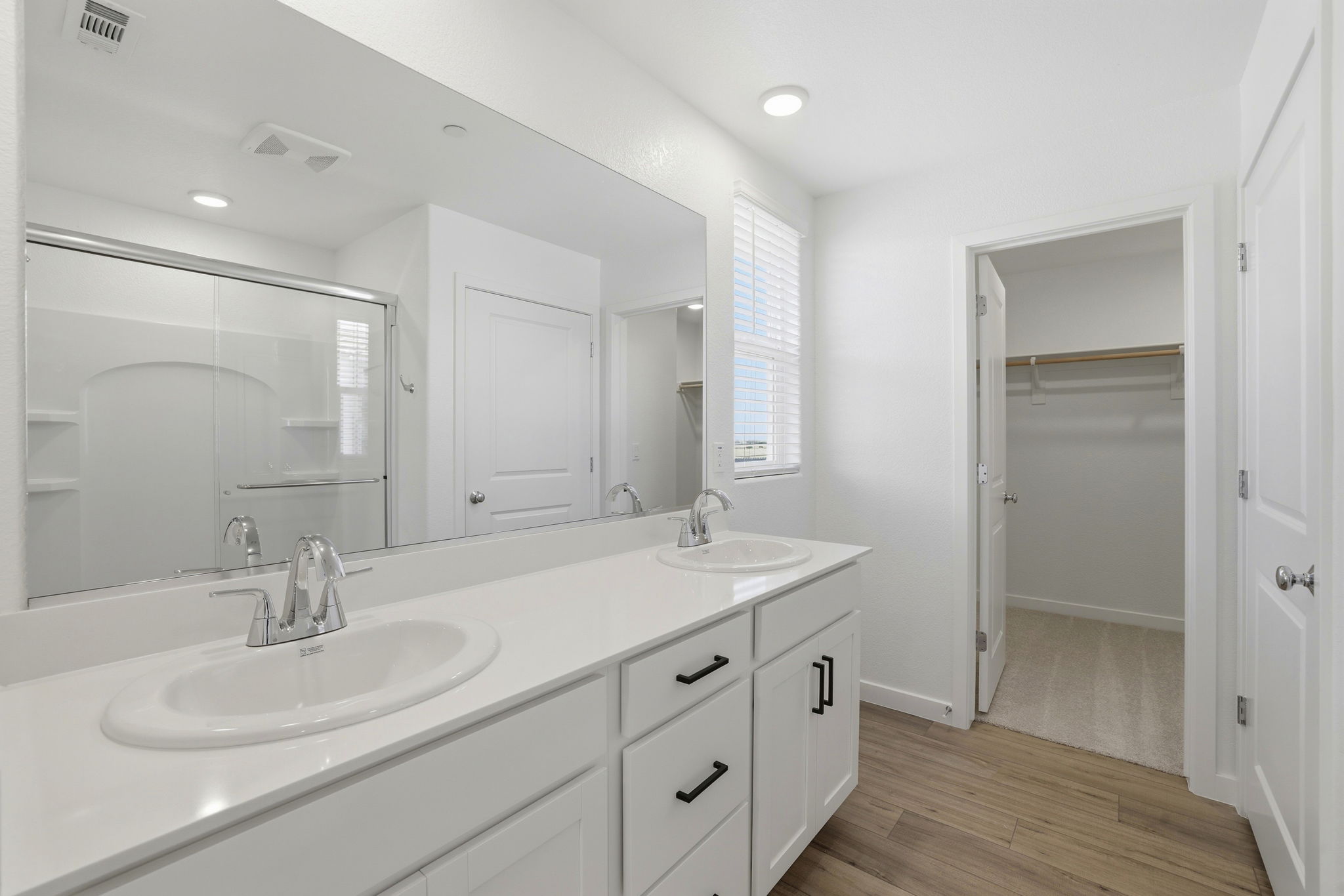 A bathroom with a large mirror.