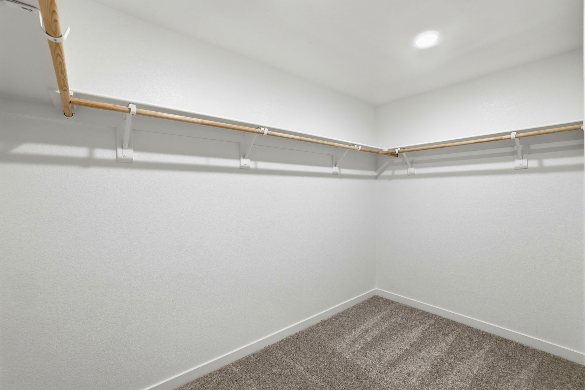 A white wall with a white floor.