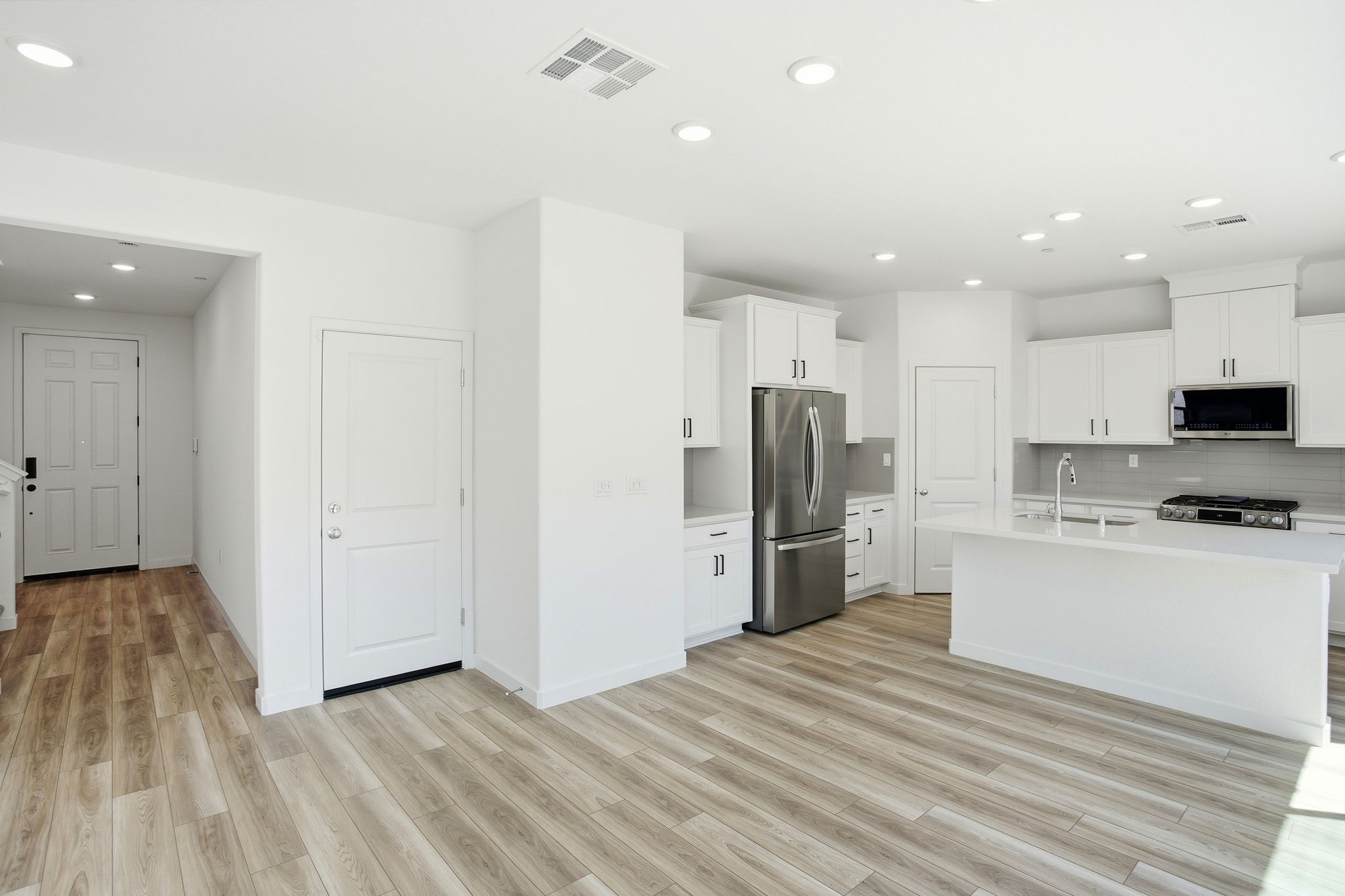 A kitchen with white cabinets.