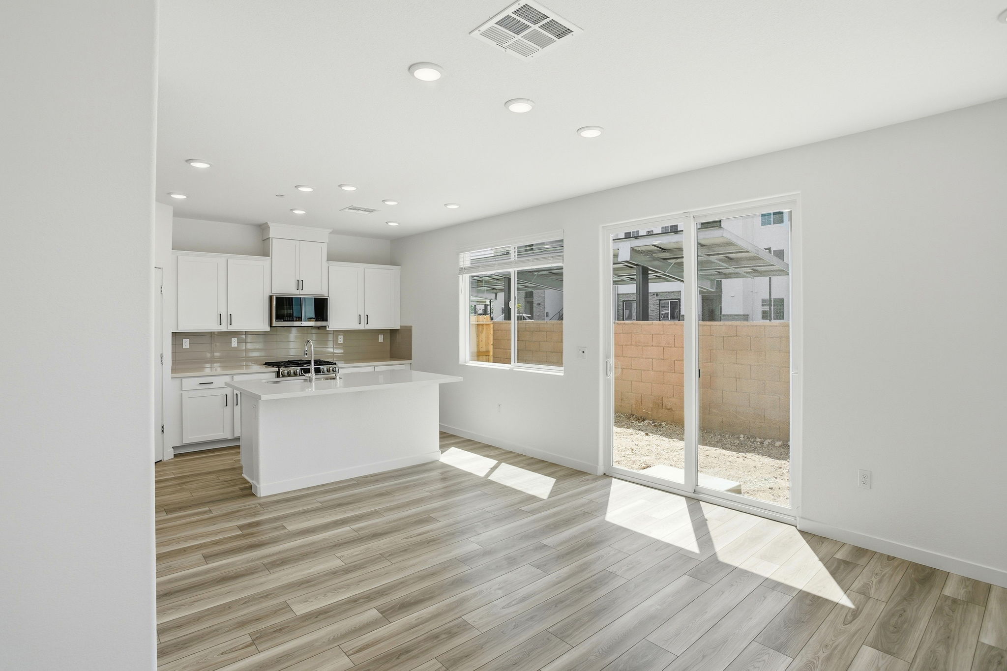 A kitchen with white cabinets.