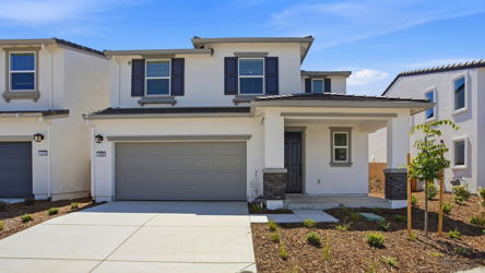 A white house with a garage.