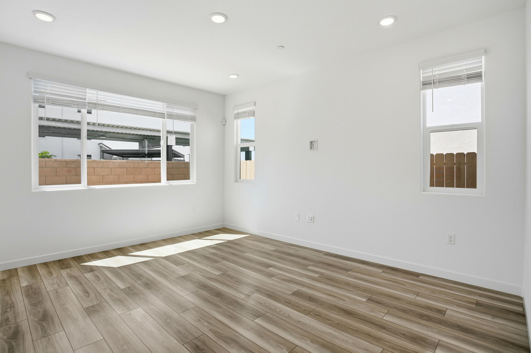 A room with a wood floor and windows.