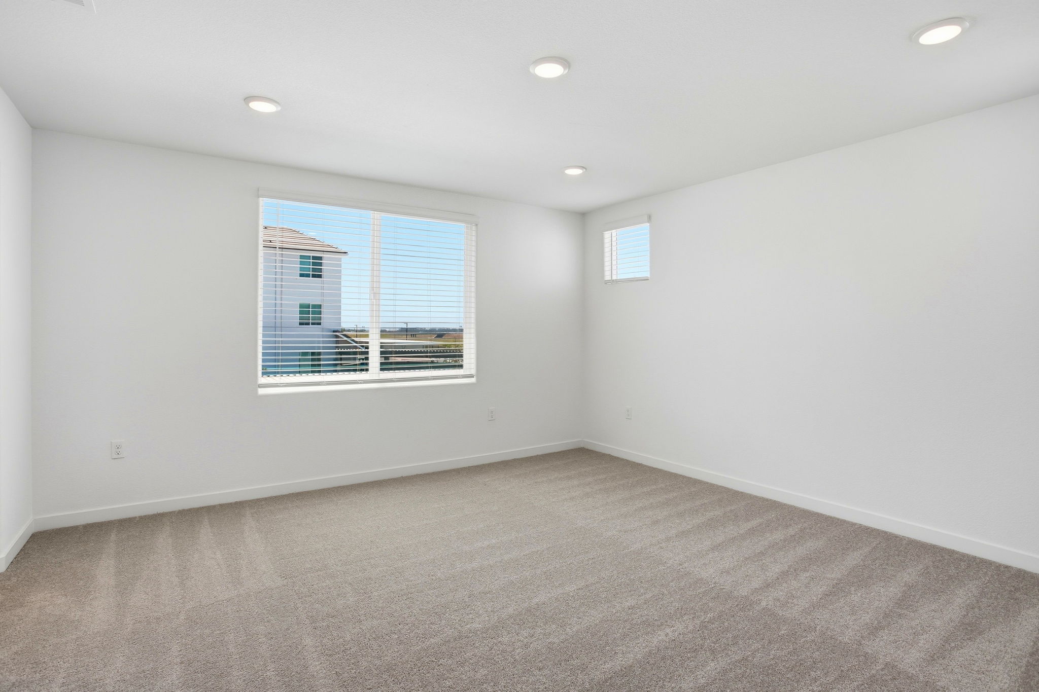 A room with a window and a carpet.
