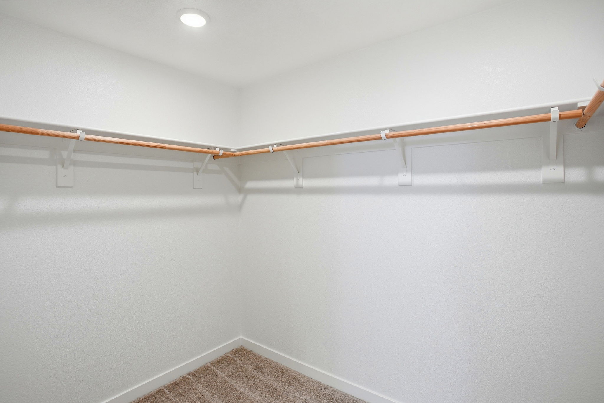 A white wall with a wooden railing.