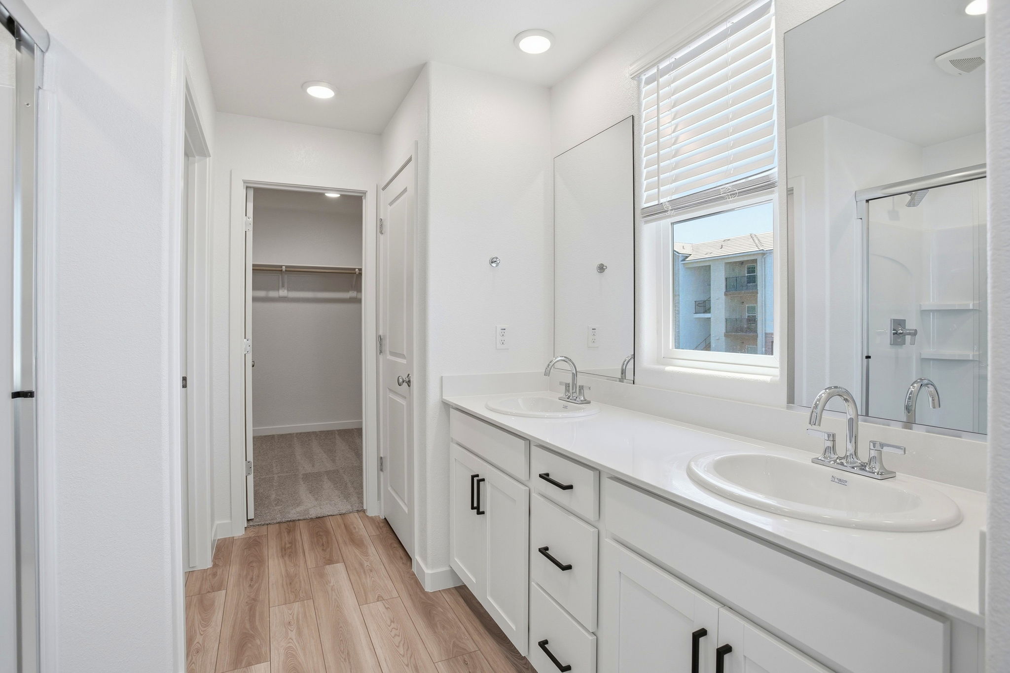 A bathroom with a large mirror.