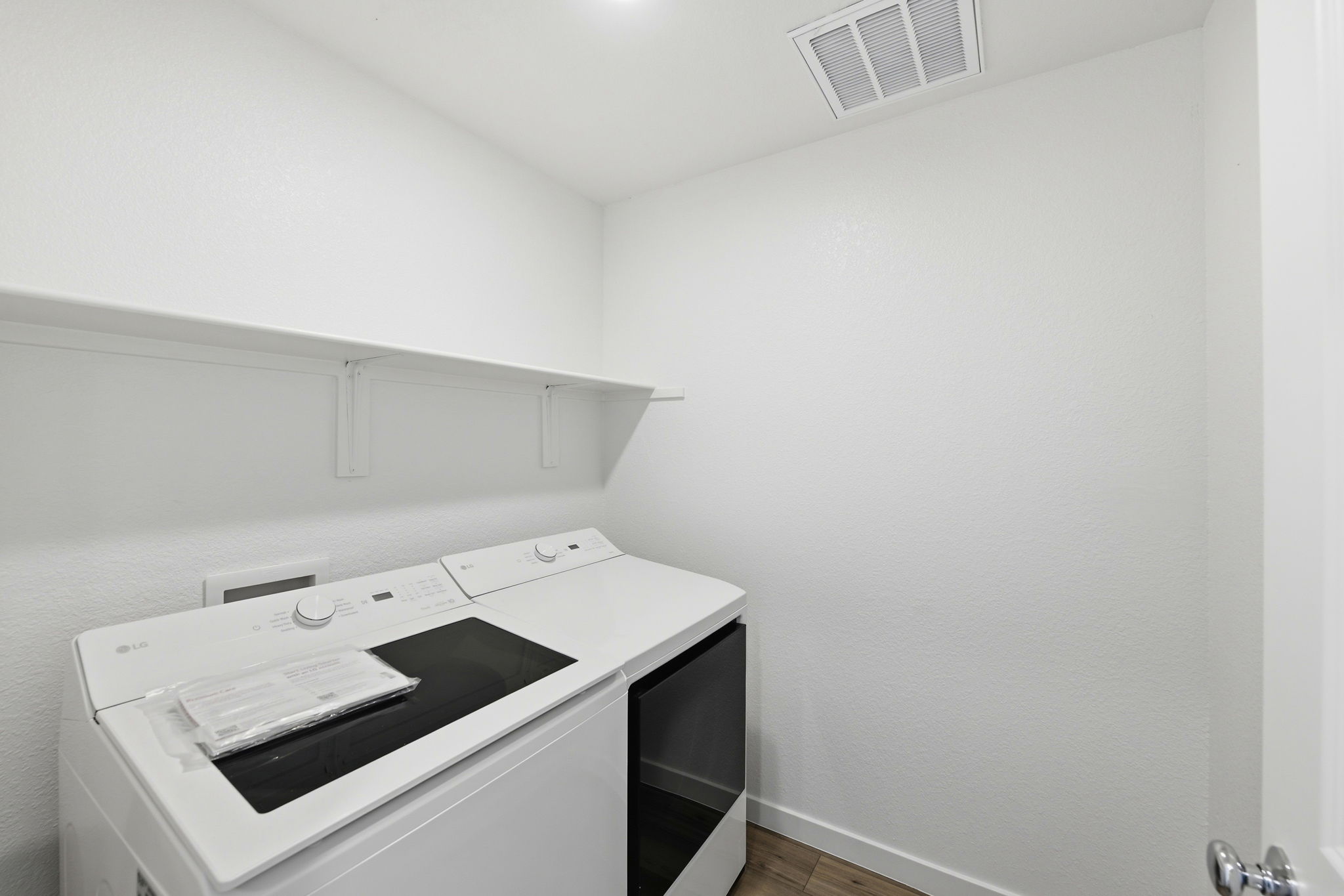 A white room with a black table and white walls.