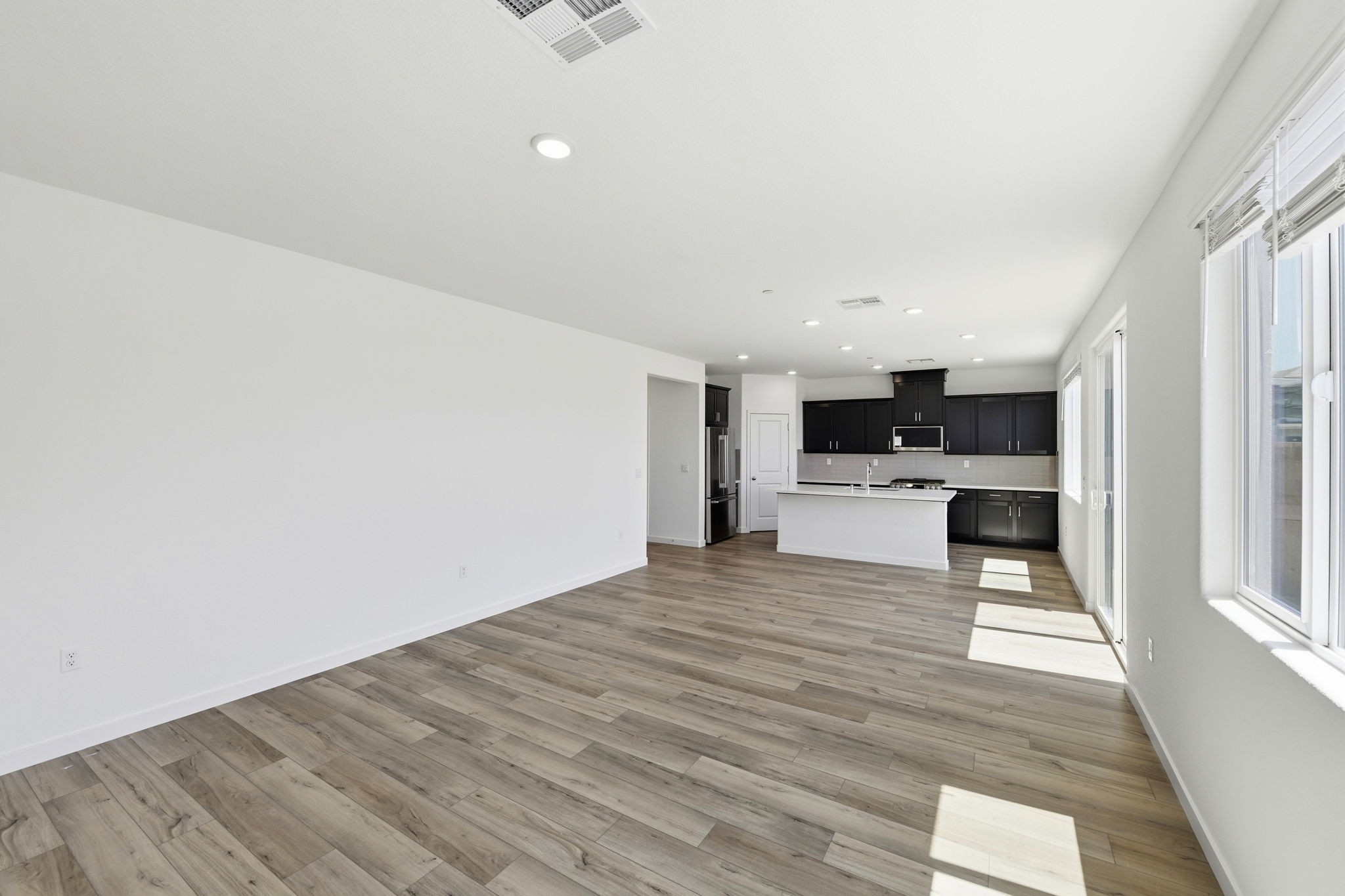 A room with a wood floor and white walls.