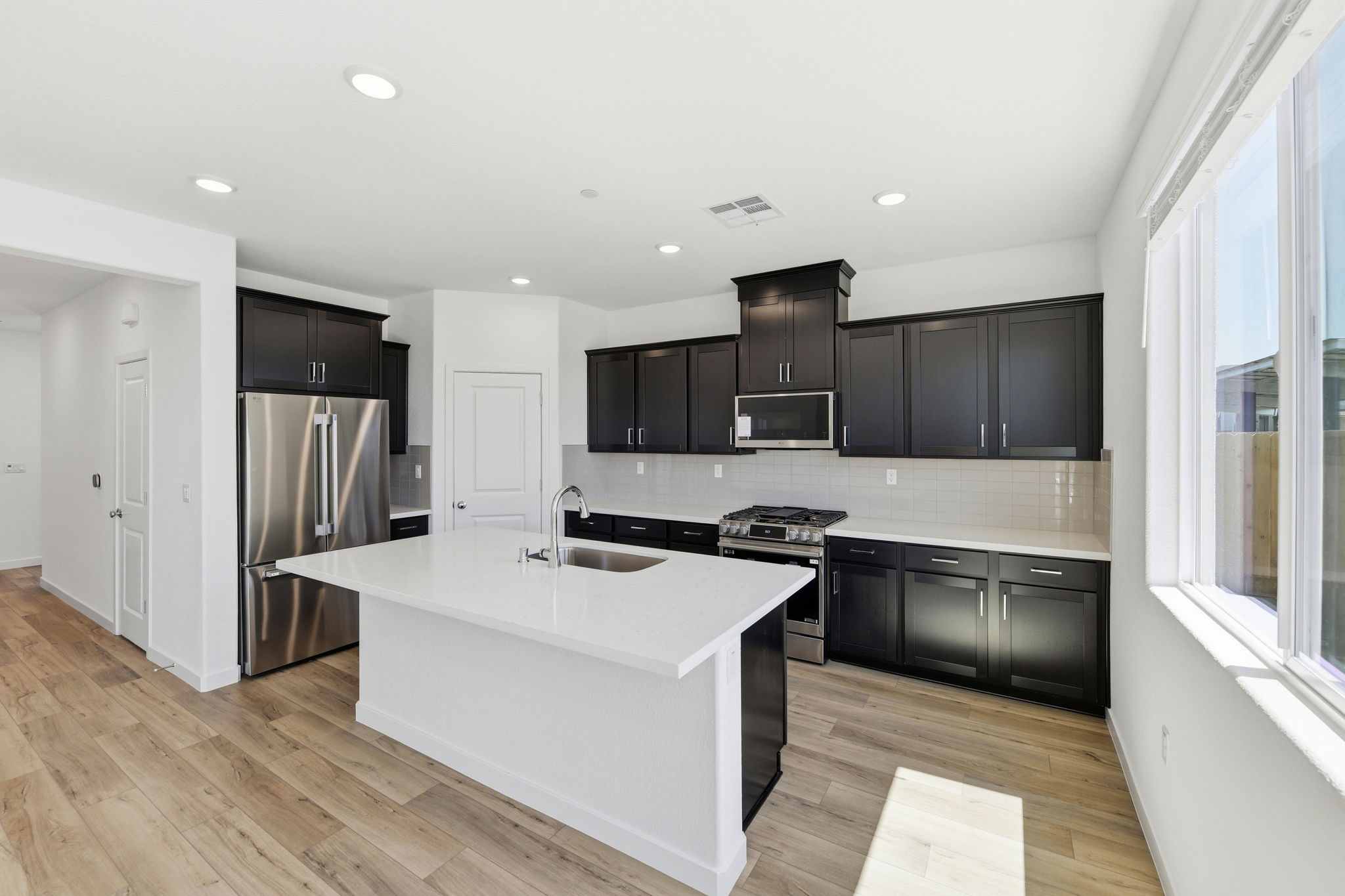 A kitchen with black cabinets.