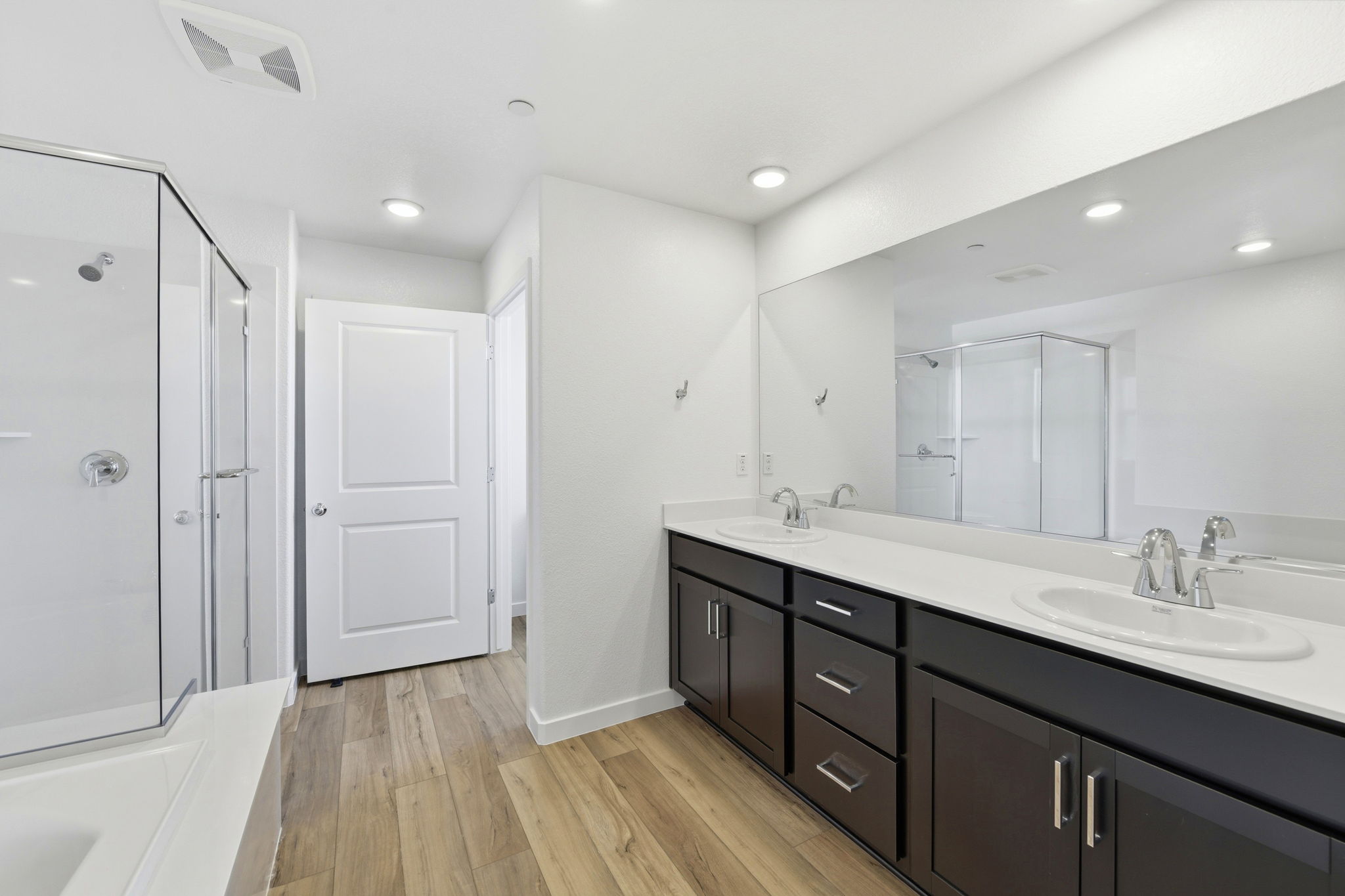 A bathroom with a large mirror.