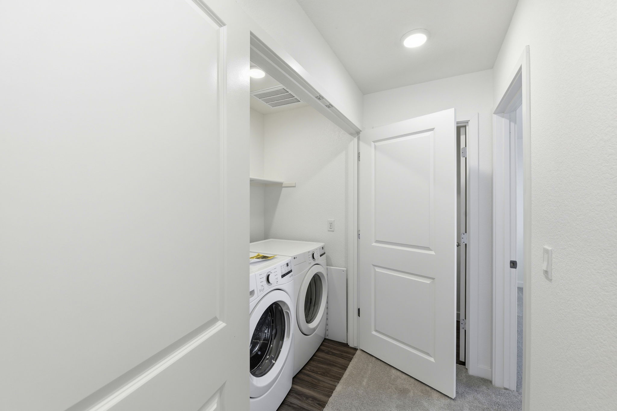 A washing machine in a room.