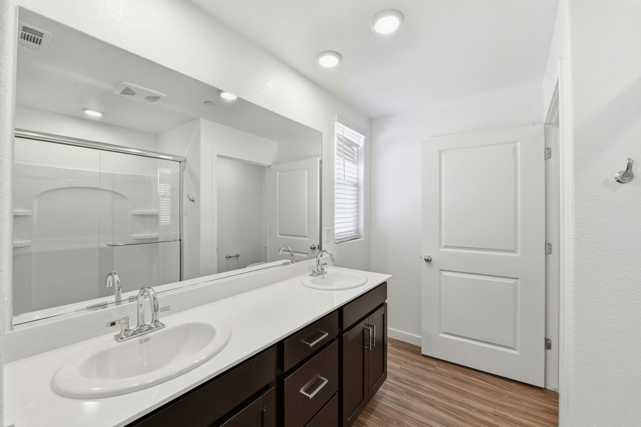 A bathroom with a large mirror.