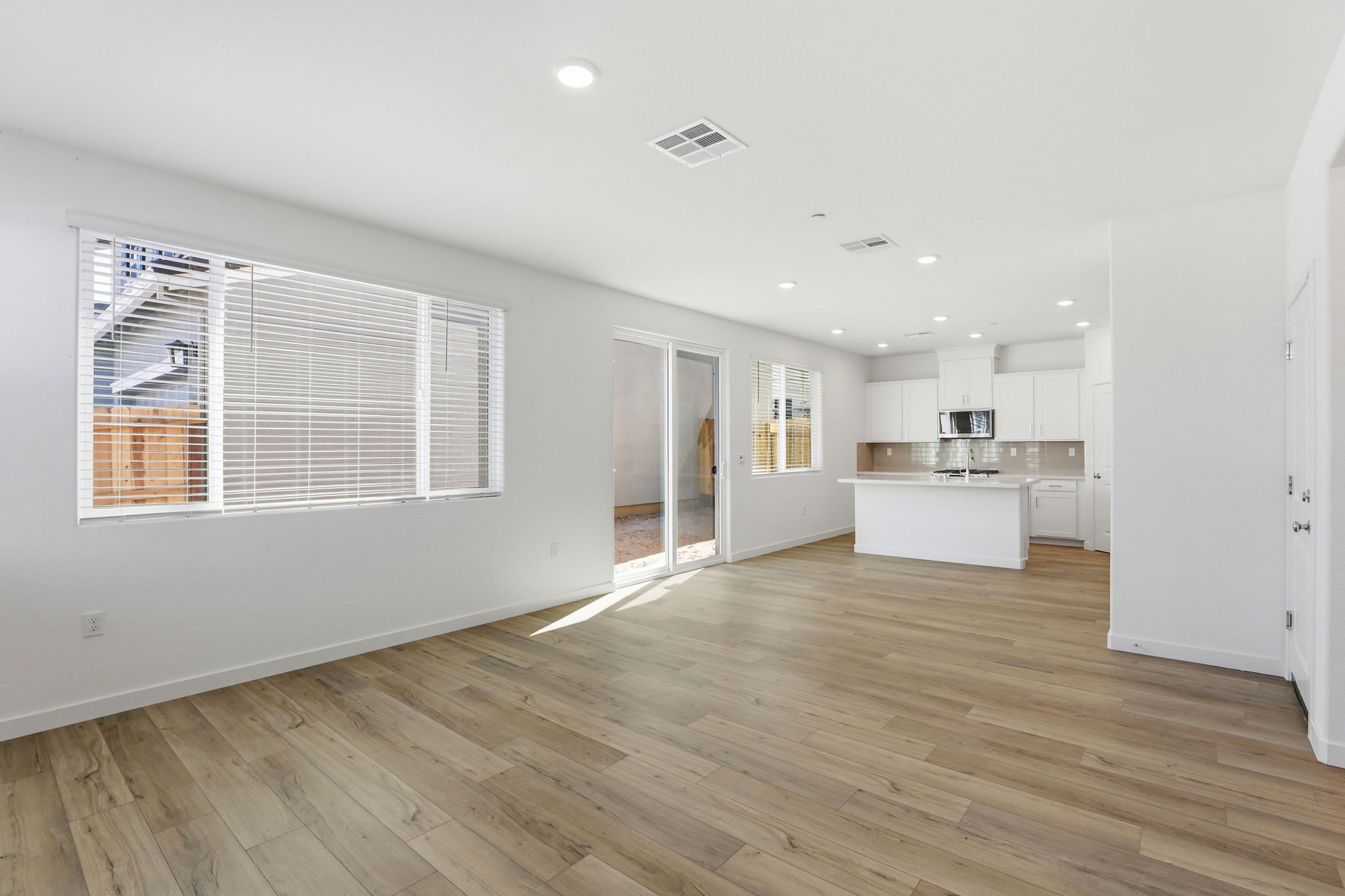 A large kitchen with white walls.